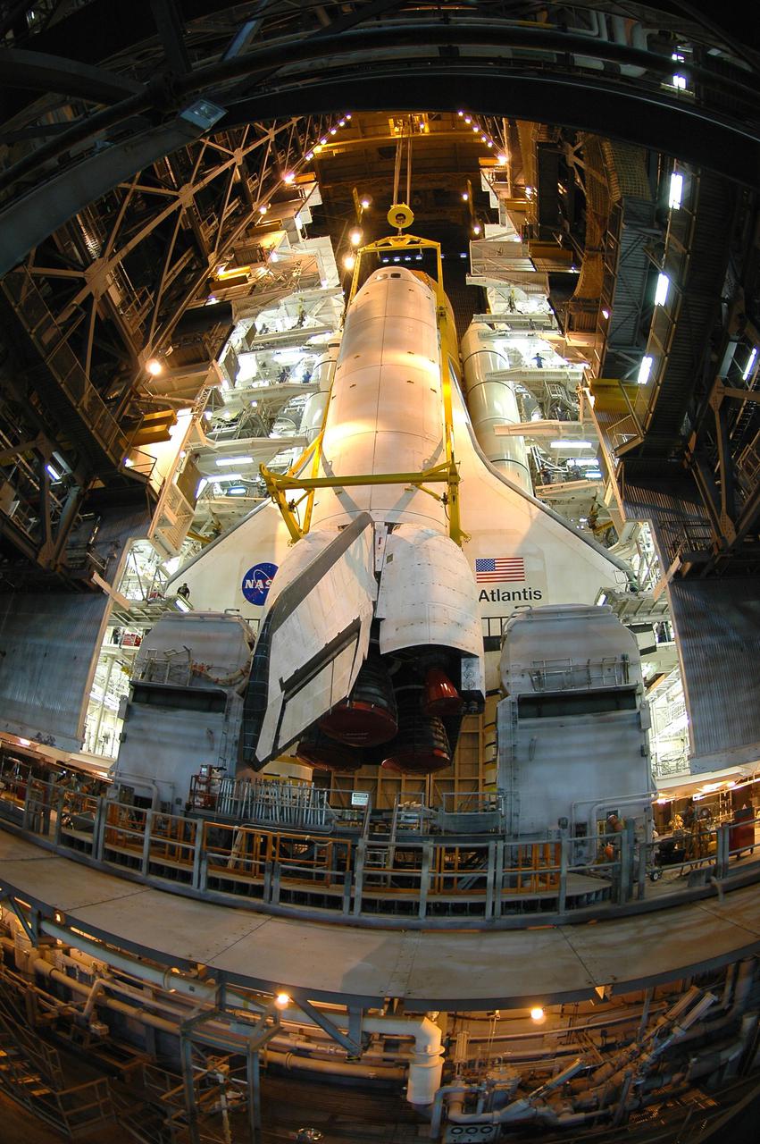 KENNEDY SPACE CENTER, FLA.  - In the Vehicle Assembly Building, a fisheye lens captures Space Shuttle Atlantis as it is lifted from its External Tank_Solid Rocket Booster stack. The orbiter will be lowered into the transfer aisle and rolled back to Orbiter Processing Facility (OPF) bay 1.  Once in the OPF, processing will begin for mission STS-115, the 19th flight to the International Space Station. The tank, ET-120, is the first redesigned ET to arrive at KSC and will undergo further testing before Return to Flight mission STS-121 next year.