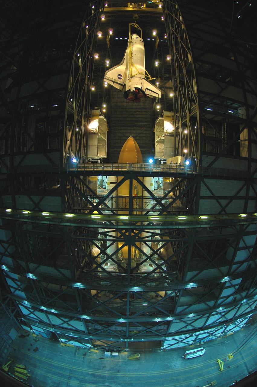 KENNEDY SPACE CENTER, FLA.  - In the Vehicle Assembly Building, a fisheye lens captures Space Shuttle Atlantis as it is lifted above its External Tank_Solid Rocket Booster stack. The orbiter will be lowered into the transfer aisle and rolled back to Orbiter Processing Facility (OPF) bay 1. Once in the OPF, processing will begin for mission STS-115, the 19th flight to the International Space Station. The tank, ET-120, is the first redesigned ET to arrive at KSC and will undergo further testing before Return to Flight mission STS-121 next year.
