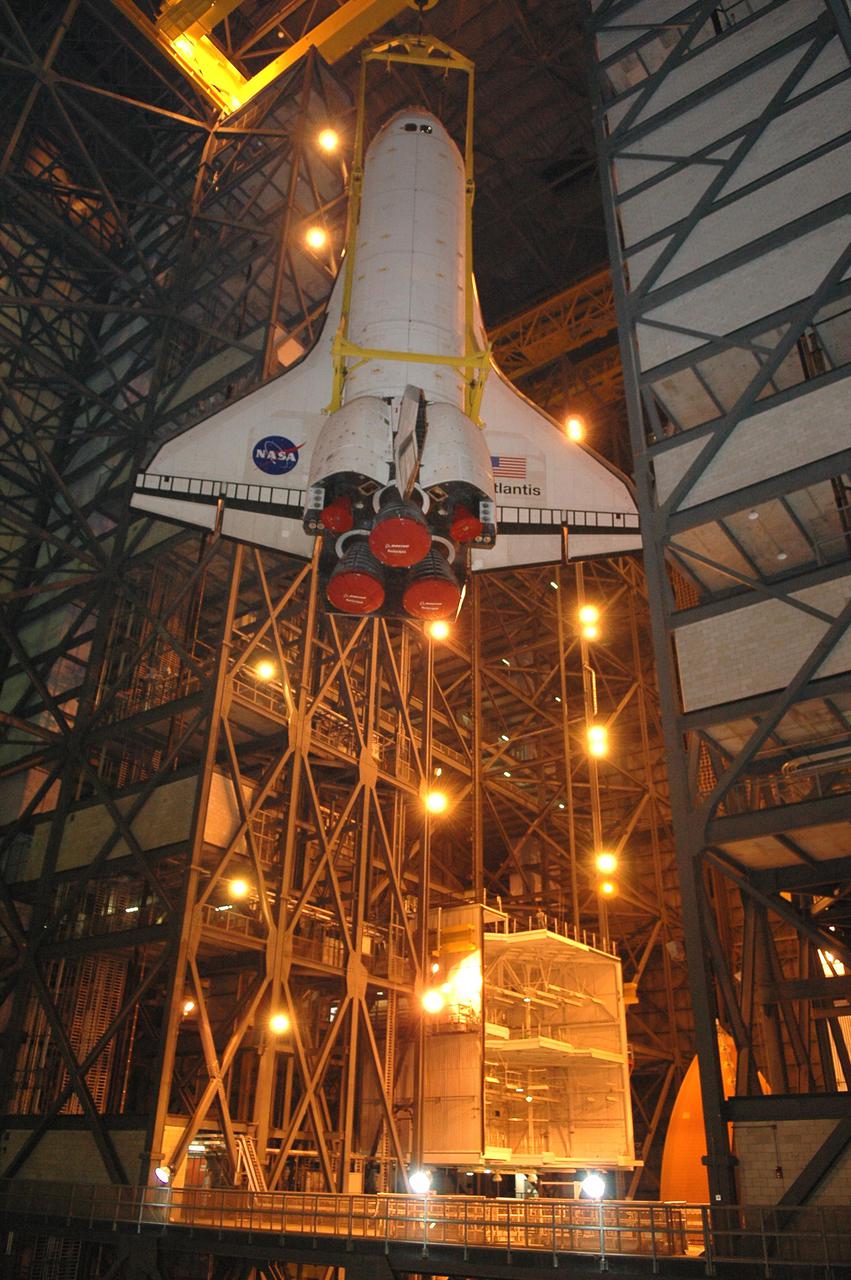 KENNEDY SPACE CENTER, FLA.  - In the Vehicle Assembly Building, Space Shuttle Atlantis is lowered into the transfer aisle after being demated from its External Tank_Solid Rocket Booster stack. The orbiter will be rolled back to Orbiter Processing Facility (OPF) bay 1 where processing will begin for mission STS-115, the 19th flight to the International Space Station. The tank, ET-120, is the first redesigned ET to arrive at KSC and will undergo further testing before Return to Flight mission STS-121 next year.