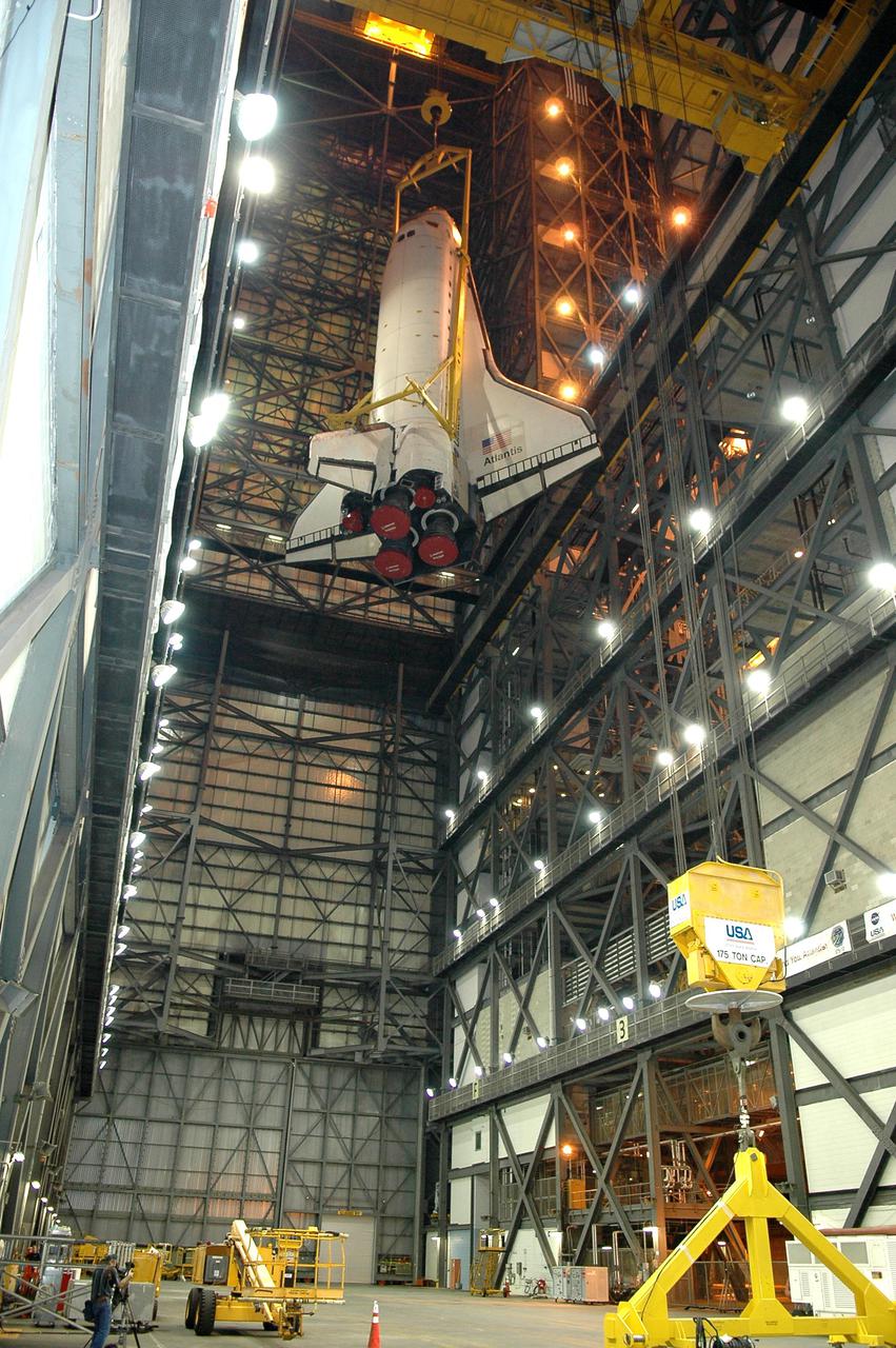 KENNEDY SPACE CENTER, FLA.  - In the Vehicle Assembly Building, Space Shuttle Atlantis is lowered into the transfer aisle after being demated from its External Tank_Solid Rocket Booster stack. The orbiter will be rolled back to Orbiter Processing Facility bay 1 where processing will begin for mission STS-115, the 19th flight to the International Space Station. The tank, ET-120, is the first redesigned ET to arrive at KSC and will undergo further testing before Return to Flight mission STS-121 next year.