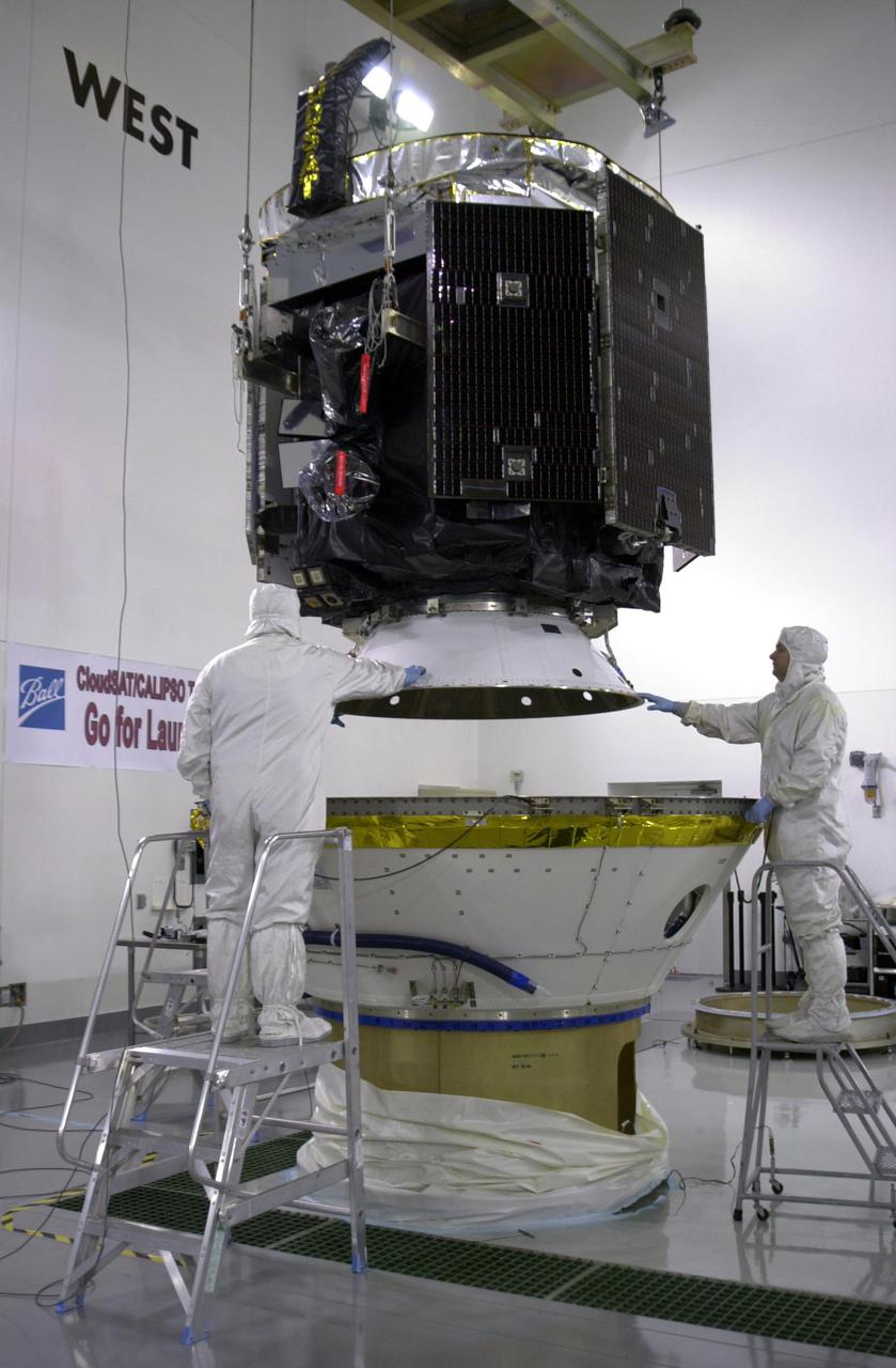 KENNEDY SPACE CENTER, FLA.  - In a clean room at Vandenberg Air Force Base in California, workers ensure NASA's CloudSat spacecraft is lowered safely into the lower portion of the Delta Payload Attach Fitting.  CloudSat joins the CALIPSO spacecraft for launch.  CALIPSO stands for Cloud-Aerosol Lidar and Infrared Pathfinder Satellite Observation. CALIPSO and CloudSat are highly complementary satellites that will provide never-before-seen 3-D perspectives of how clouds and aerosols form, evolve, and affect weather and climate. CALIPSO and CloudSat will fly in formation with three other satellites in the A-train constellation to enhance understanding of our climate system. Launch of CALIPSO_CloudSat aboard a Boeing Delta II rocket is scheduled for 3:01 a.m. PDT Sept. 29.