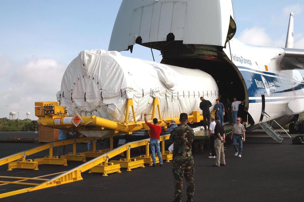 KENNEDY SPACE CENTER, FLA.  - At the Skid Strip on Cape Canaveral Air Force Station (CCAFS), the second stage Centaur is offloaded from a Russian air cargo plane. The Centaur is the upper stage of the Atlas V configuration that will launch the New Horizons spacecraft from Launch Complex 41 at CCAFS. New Horizons is designed to help us understand worlds at the edge of our solar system by making the first reconnaissance of Pluto and Charon - a 'double planet' and the last planet in our solar system to be visited by spacecraft. The mission will then visit one or more objects in the Kuiper Belt region beyond Neptune. New Horizons is scheduled to launch in January 2006, swing past Jupiter for a gravity boost and scientific studies in February or March 2007, and reach Pluto and its moon, Charon, in July 2015.