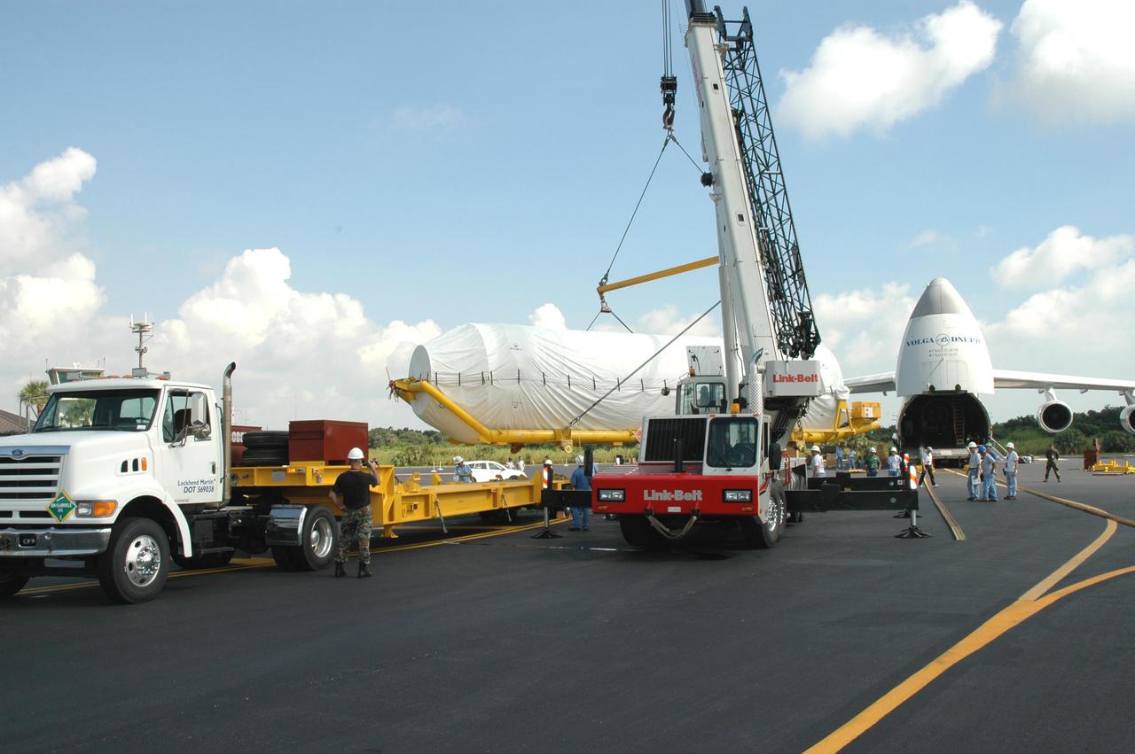 KENNEDY SPACE CENTER, FLA.  - At the Skid Strip on Cape Canaveral Air Force Station (CCAFS), a crane lifts the second stage Centaur onto the back of a transporter trailer.  The Centaur is the upper stage of the Atlas V configuration that will launch the New Horizons spacecraft from Launch Complex 41 at CCAFS. New Horizons is designed to help us understand worlds at the edge of our solar system by making the first reconnaissance of Pluto and Charon - a 'double planet' and the last planet in our solar system to be visited by spacecraft. The mission will then visit one or more objects in the Kuiper Belt region beyond Neptune. New Horizons is scheduled to launch in January 2006, swing past Jupiter for a gravity boost and scientific studies in February or March 2007, and reach Pluto and its moon, Charon, in July 2015.