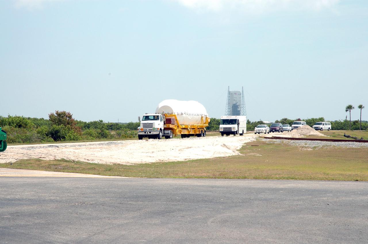 KENNEDY SPACE CENTER, FLA.  - The truck transporting the second stage Centaur drives away from the Skid Strip on Cape Canaveral Air Force Station (CCAFS) to its destination - the Atlas Space Operations Center.   The Centaur is the upper stage of the Atlas V configuration that will launch the New Horizons spacecraft from Launch Complex 41 at CCAFS. New Horizons is designed to help us understand worlds at the edge of our solar system by making the first reconnaissance of Pluto and Charon - a 'double planet' and the last planet in our solar system to be visited by spacecraft. The mission will then visit one or more objects in the Kuiper Belt region beyond Neptune. New Horizons is scheduled to launch in January 2006, swing past Jupiter for a gravity boost and scientific studies in February or March 2007, and reach Pluto and its moon, Charon, in July 2015.