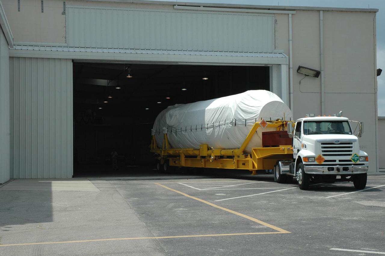 KENNEDY SPACE CENTER, FLA.  - The truck transporting the second stage Centaur backs into the Atlas Space Operations Center on Cape Canaveral Air Force Station (CCAFS).    The Centaur is the upper stage of the Atlas V configuration that will launch the New Horizons spacecraft from Launch Complex 41 at CCAFS. New Horizons is designed to help us understand worlds at the edge of our solar system by making the first reconnaissance of Pluto and Charon - a 'double planet' and the last planet in our solar system to be visited by spacecraft. The mission will then visit one or more objects in the Kuiper Belt region beyond Neptune. New Horizons is scheduled to launch in January 2006, swing past Jupiter for a gravity boost and scientific studies in February or March 2007, and reach Pluto and its moon, Charon, in July 2015.