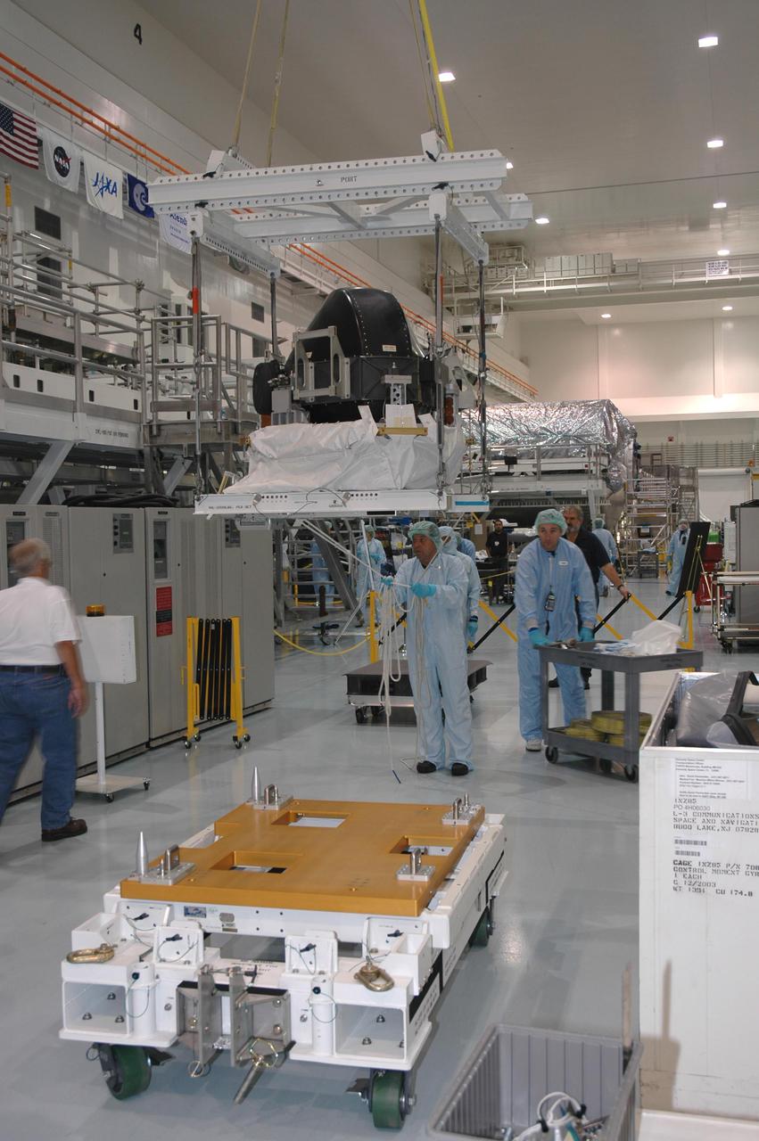 KENNEDY SPACE CENTER, FLA. - In the Space Station Processing Facility, the Control Moment Gyroscope (CMG) is moved toward a stand prior to its being returned to the vendor for repair. The faulty CMG was removed from the International Space Station and replaced with a new one on mission STS-114 in August. A control moment gyroscope is an actuator used to apply very high attitude-control torques to agile spacecraft. The Space Station uses four massive control moment gyroscopes to maintain the Station’s orientation in space.