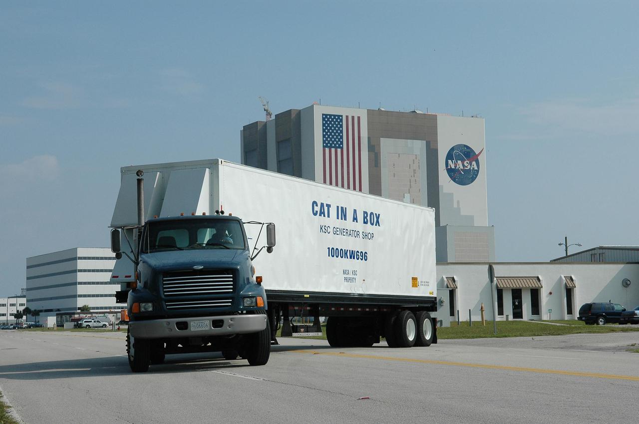 KENNEDY SPACE CENTER, FLA.  - A truck with a 1-megawatt generator drives past NASA Kennedy Space Center’s Vehicle Assembly Building on its way to Stennis Space Center in Mississippi.  Stennis suffered damage and power outages from Hurricane Katrina.   KSC is sending a helicopter with medical supplies and an Emergency Medical Technician to Stennis, plus a 1-megawatt generator, 125- and 225-kilowatt generators, and 1,000 gallons of diesel fuel.  Michoud Assembly Facility near New Orleans was also left without power.  A NASA plane is carrying medical supplies, food and chain saws, as well as a physician and two high voltage technicians to Michoud to ensure the facility can safely receive power when the main electricity grid comes online.  In addition, a 14-person security team is also going to Michoud to relieve the security professionals at that location.
