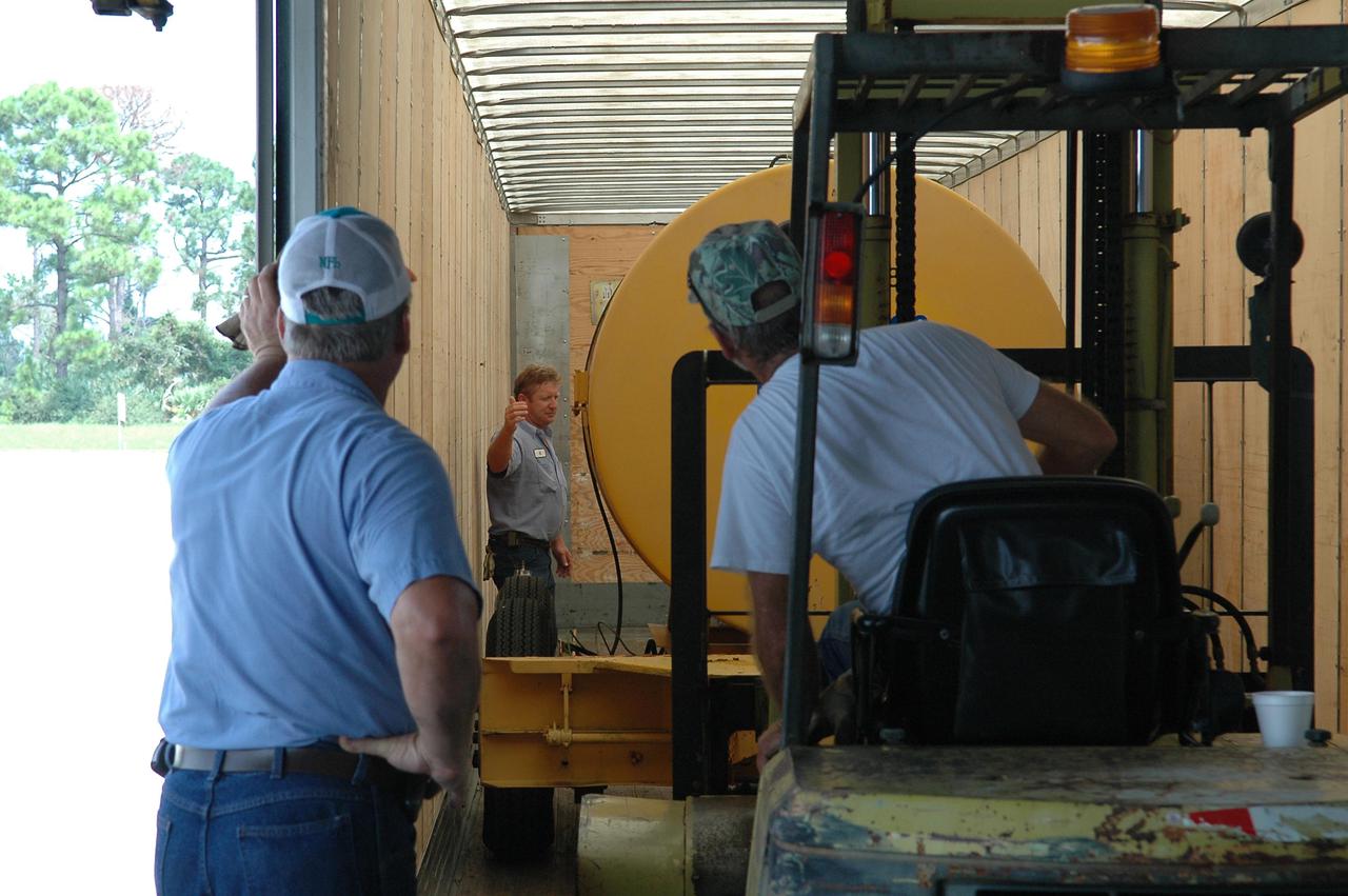 KENNEDY SPACE CENTER, FLA.  - A container of diesel fuel is loaded onto a truck for a trip to Stennis Space Center in Mississippi.  Stennis suffered damage and power outages from Hurricane Katrina.   KSC is sending a helicopter with medical supplies and an Emergency Medical Technician to Stennis, plus a 1-megawatt generator, 125- and 225-kilowatt generators, and 1,000 gallons of diesel fuel.  Michoud Assembly Facility near New Orleans was also left without power .  A NASA plane is carrying medical supplies, food and chain saws, as well as a physician and two high voltage technicians to Michoud to ensure the facility can safely receive power when the main electricity grid comes online.  In addition, a 14-person security team is also going to Michoud to relieve the security professionals at that location.