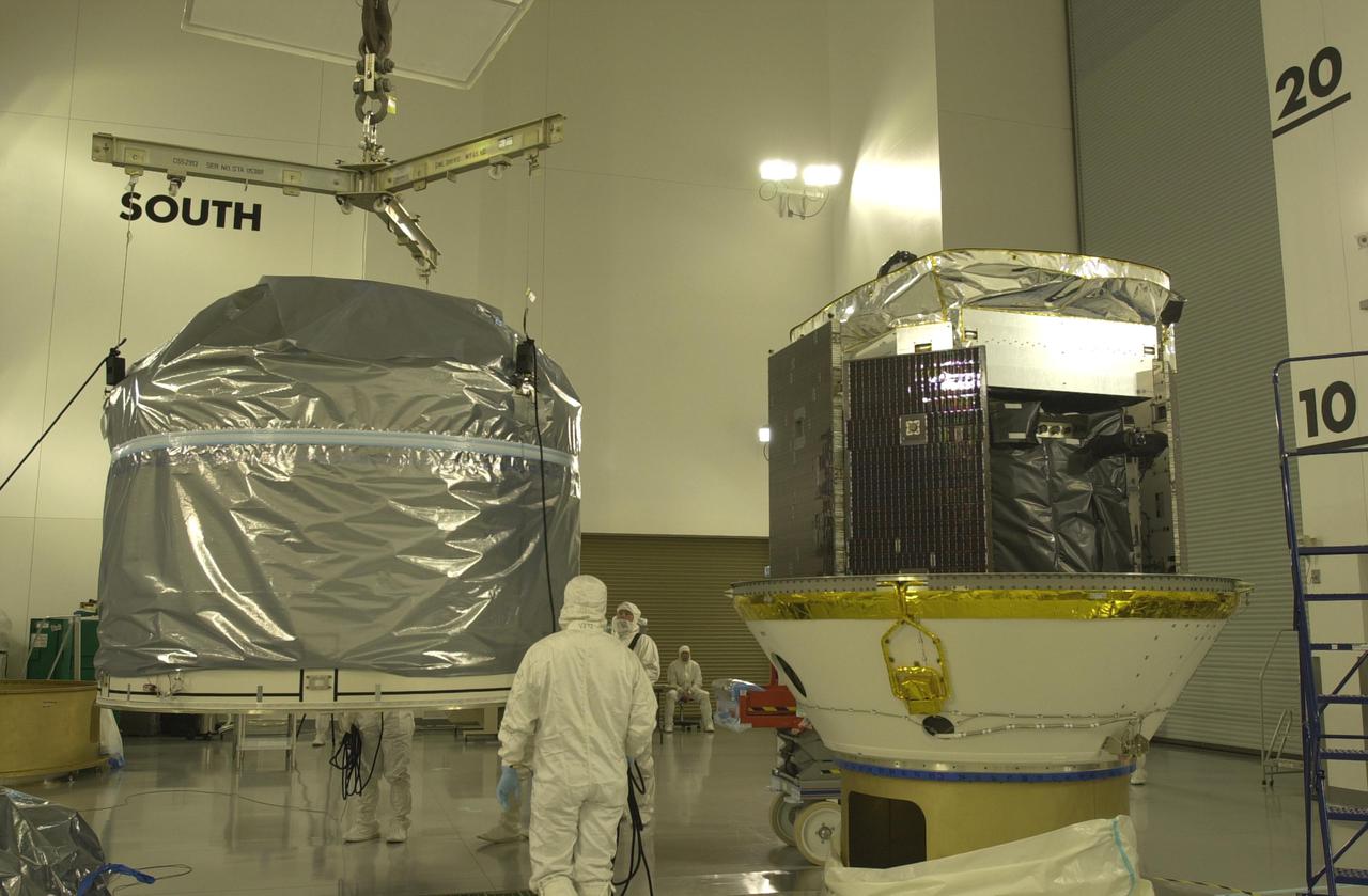VANDENBERG AIR FORCE BASE, CALIF. - Inside the Astrotech Payload Processing Facility on Vandenberg Air Force Base in California, the upper Delta Payload Attach Fitting (UDPAF) at left is fitted with a crane to lift it and mate it with the lower Delta Payload Attach Fitting (LDPAF) at right. The UDPAF will hold the CALIPSO satellite and the LDPAF holds the CloudSat satellite. The two sections will be mated. CALIPSO stands for Cloud-Aerosol Lidar and Infrared Pathfinder Satellite Observation. CALIPSO and CloudSat are highly complementary satellites that will provide never-before-seen 3-D perspectives of how clouds and aerosols form, evolve, and affect weather and climate. CALIPSO and CloudSat will fly in formation with three other satellites in the A-train constellation to enhance understanding of our climate system. Launch of CALIPSO_CloudSat aboard a Boeing Delta II rocket is scheduled for 3:01 a.m. PDT Sept. 29.