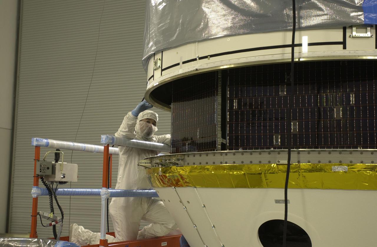 VANDENBERG AIR FORCE BASE, CALIF. - Inside the Astrotech Payload Processing Facility on Vandenberg Air Force Base in California, the upper Delta Payload Attach Fitting (UDPAF) is lowered toward the lower Delta Payload Attach Fitting (LDPAF). The LDPAF holds the CloudSat satellite and the UDPAF will hold the CALIPSO satellite. The two sections will be mated. CALIPSO stands for Cloud-Aerosol Lidar and Infrared Pathfinder Satellite Observation. CALIPSO and CloudSat are highly complementary satellites that will provide never-before-seen 3-D perspectives of how clouds and aerosols form, evolve, and affect weather and climate. CALIPSO and CloudSat will fly in formation with three other satellites in the A-train constellation to enhance understanding of our climate system. Launch of CALIPSO_CloudSat aboard a Boeing Delta II rocket is scheduled for 3:01 a.m. PDT Sept. 29.