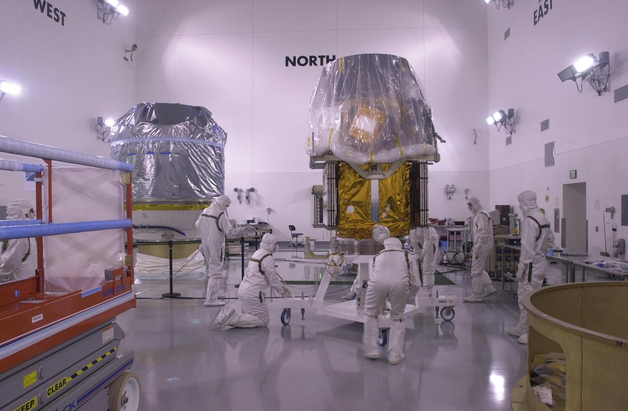 VANDENBERG AIR FORCE BASE, CALIF. —  Inside the Astrotech Payload Processing Facility on Vandenberg Air Force Base in California, workers prepare the CALIPSO spacecraft for lifting.  CALIPSO will be mated with the upper Delta Payload Attach Fitting (UDPAF).  Later the UDPAF will be mated with the lower Delta Payload Attach Fitting, which contains the CloudSat satellite.  The PAF is the interface between the spacecraft and the second stage of the rocket.  CALIPSO stands for Cloud-Aerosol Lidar and Infrared Pathfinder Satellite Observation. CALIPSO and CloudSat are highly complementary satellites that will provide never-before-seen 3-D perspectives of how clouds and aerosols form, evolve, and affect weather and climate. CALIPSO and CloudSat will fly in formation with three other satellites in the A-train constellation to enhance understanding of our climate system. Launch of CALIPSO_CloudSat aboard a Boeing Delta II rocket is scheduled for 3:01 a.m. PDT Sept. 29.