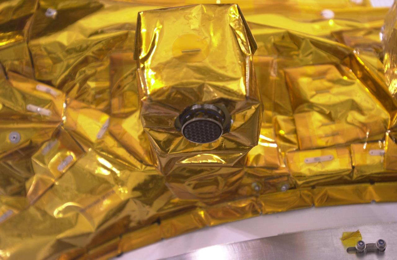 VANDENBERG AIR FORCE BASE, CALIF. —  Inside the Astrotech Payload Processing Facility on Vandenberg Air Force Base in California, the CALIPSO spacecraft is being prepared for mating with the upper Delta Payload Attach Fitting (UDPAF).   Later the UDPAF will be mated with the lower Delta Payload Attach Fitting, which contains the CloudSat satellite.  The PAF is the interface between the spacecraft and the second stage of the rocket.  CALIPSO stands for Cloud-Aerosol Lidar and Infrared Pathfinder Satellite Observation. CALIPSO and CloudSat are highly complementary satellites that will provide never-before-seen 3-D perspectives of how clouds and aerosols form, evolve, and affect weather and climate. CALIPSO and CloudSat will fly in formation with three other satellites in the A-train constellation to enhance understanding of our climate system. Launch of CALIPSO_CloudSat aboard a Boeing Delta II rocket is scheduled for 3:01 a.m. PDT Sept. 29.