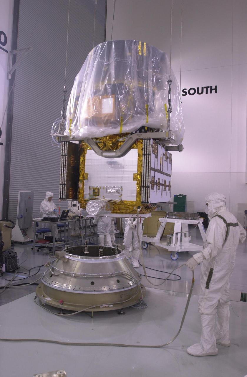 VANDENBERG AIR FORCE BASE, CALIF. —  Inside the Astrotech Payload Processing Facility on Vandenberg Air Force Base in California, an overhead crane moves the CALIPSO spacecraft toward the upper Delta Payload Attach Fitting (UDPAF).   Later the UDPAF will be mated with the lower Delta Payload Attach Fitting, which contains the CloudSat satellite.  The PAF is the interface between the spacecraft and the second stage of the rocket.  CALIPSO stands for Cloud-Aerosol Lidar and Infrared Pathfinder Satellite Observation. CALIPSO and CloudSat are highly complementary satellites that will provide never-before-seen 3-D perspectives of how clouds and aerosols form, evolve, and affect weather and climate. CALIPSO and CloudSat will fly in formation with three other satellites in the A-train constellation to enhance understanding of our climate system. Launch of CALIPSO_CloudSat aboard a Boeing Delta II rocket is scheduled for 3:01 a.m. PDT Sept. 29.