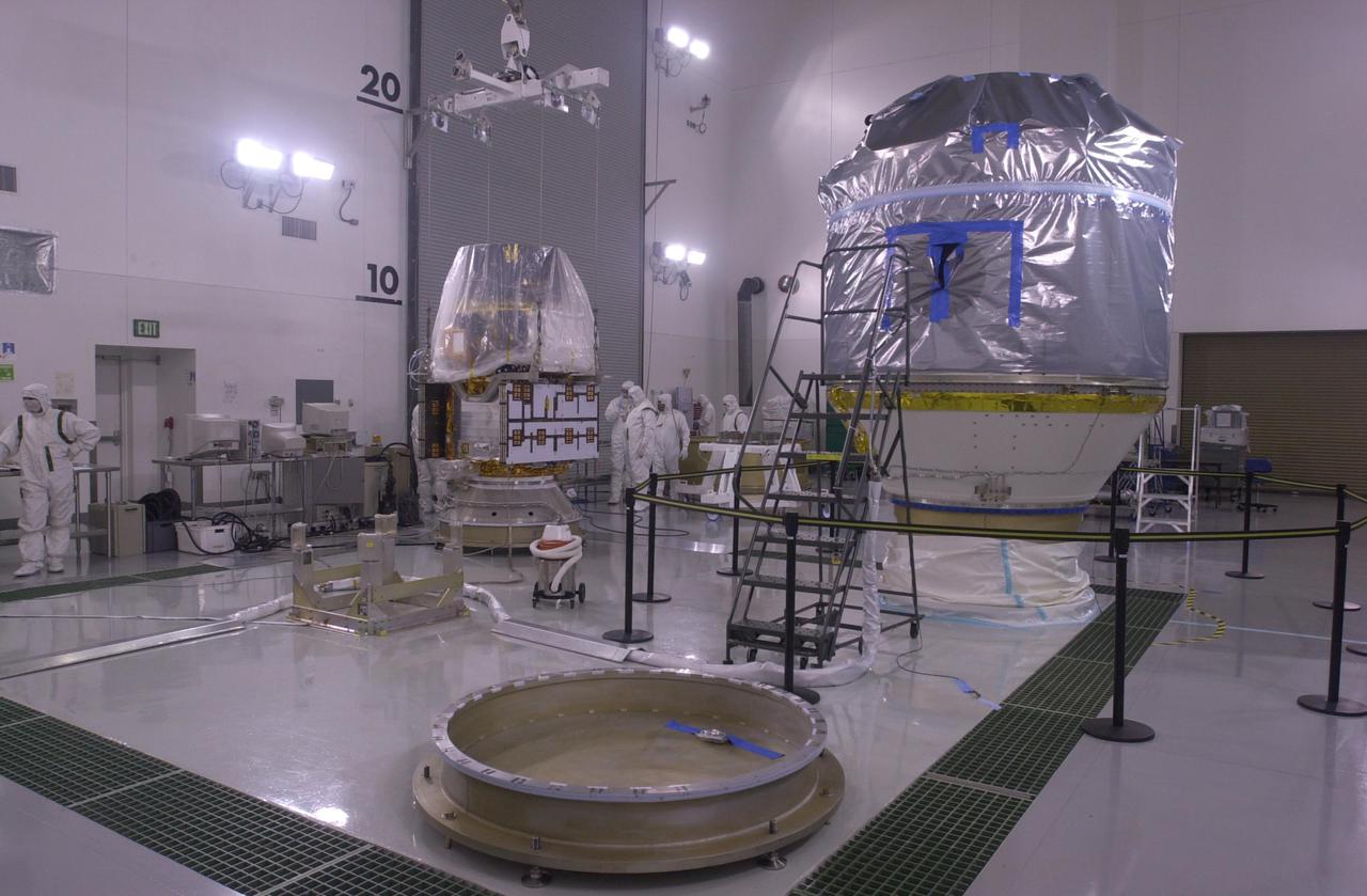 VANDENBERG AIR FORCE BASE, CALIF. —  Inside the Astrotech Payload Processing Facility on Vandenberg Air Force Base in California, the CALIPSO spacecraft (background, left) is ready for mating with the upper Delta Payload Attach Fitting (UDPAF).   Later the UDPAF will be mated with the lower Delta Payload Attach Fitting, which contains the CloudSat satellite.  The PAF is the interface between the spacecraft and the second stage of the rocket.  CALIPSO stands for Cloud-Aerosol Lidar and Infrared Pathfinder Satellite Observation. CALIPSO and CloudSat are highly complementary satellites that will provide never-before-seen 3-D perspectives of how clouds and aerosols form, evolve, and affect weather and climate. CALIPSO and CloudSat will fly in formation with three other satellites in the A-train constellation to enhance understanding of our climate system. Launch of CALIPSO_CloudSat aboard a Boeing Delta II rocket is scheduled for 3:01 a.m. PDT Sept. 29.