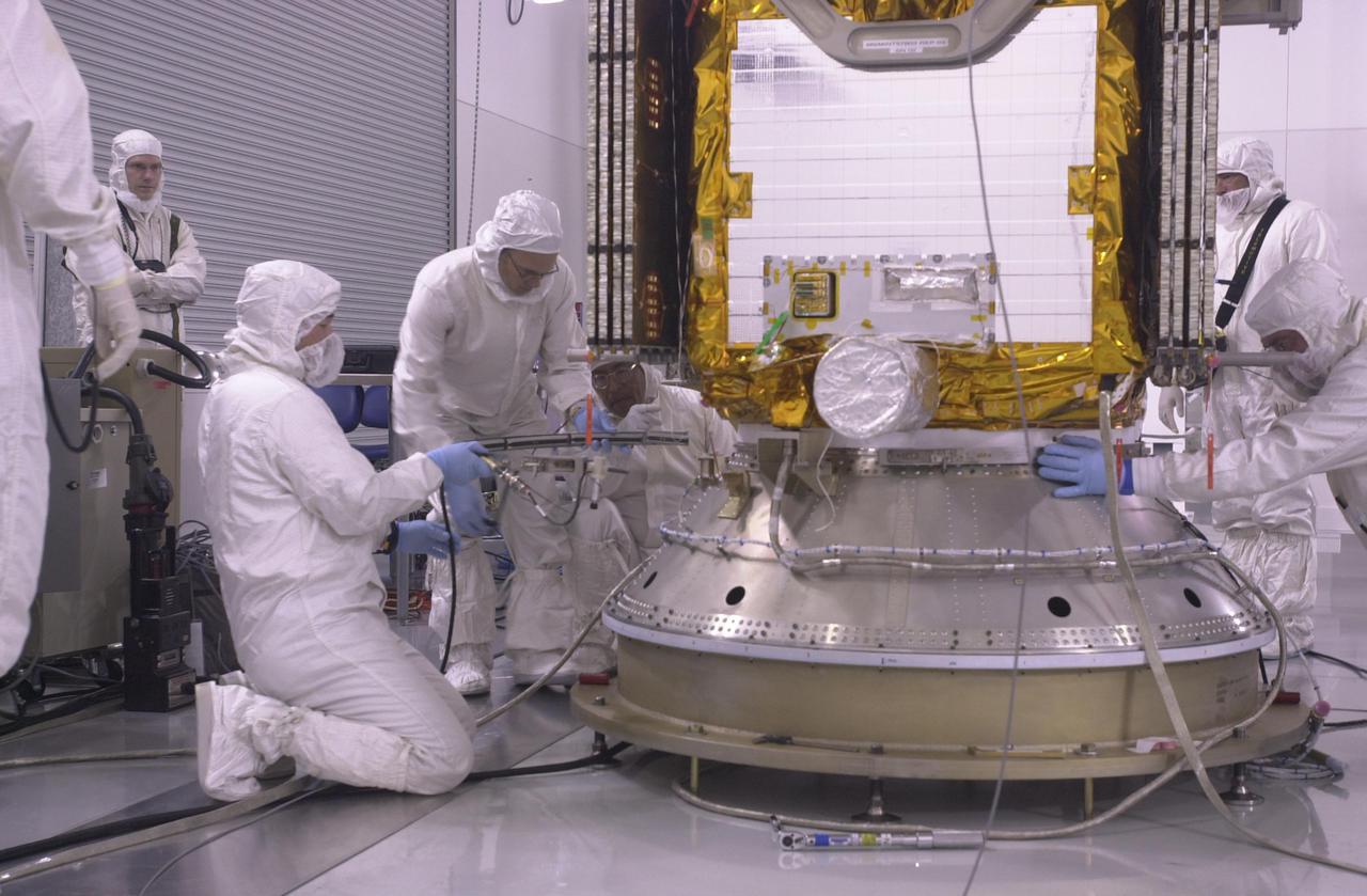 VANDENBERG AIR FORCE BASE, CALIF. — Inside the Astrotech Payload Processing Facility on Vandenberg Air Force Base in California, workers get ready to attach the CALIPSO spacecraft to the upper Delta Payload Attach Fitting (UDPAF).  Later the UDPAF will be mated with the lower Delta Payload Attach Fitting, which contains the CloudSat satellite.  The PAF is the interface between the spacecraft and the second stage of the rocket.  CALIPSO stands for Cloud-Aerosol Lidar and Infrared Pathfinder Satellite Observation. CALIPSO and CloudSat are highly complementary satellites that will provide never-before-seen 3-D perspectives of how clouds and aerosols form, evolve, and affect weather and climate. CALIPSO and CloudSat will fly in formation with three other satellites in the A-train constellation to enhance understanding of our climate system. Launch of CALIPSO_CloudSat aboard a Boeing Delta II rocket is scheduled for 3:01 a.m. PDT Sept. 29.