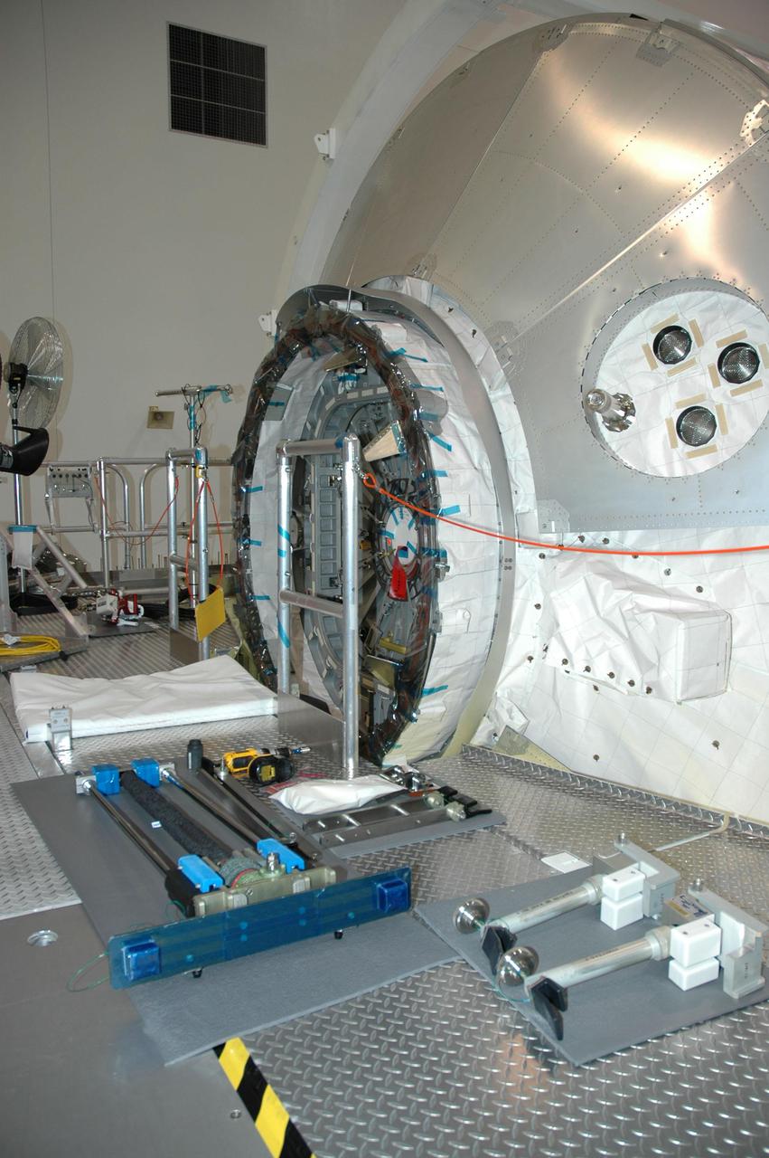 KENNEDY SPACE CENTER, FLA. — In the Space Station Processing Facility at NASA’s Kennedy Space Center, the Multi-Purpose Logistics Module (MPLM) Raffaello sits on a work stand prior to opening of the hatch. Raffaello flew on mission STS-114 to the International Space Station, returning with about 7,000 pounds of Station material. The module will be aired out before workers enter to remove the contents. Three MPLMs were built by the Italian space agency Alenia Aerospazio. The other two are Leonardo and Donatello. The MPLMs are carried in the payload bay of a Shuttle orbiter, and carry materials, supplies and even experiments to the Space Station.