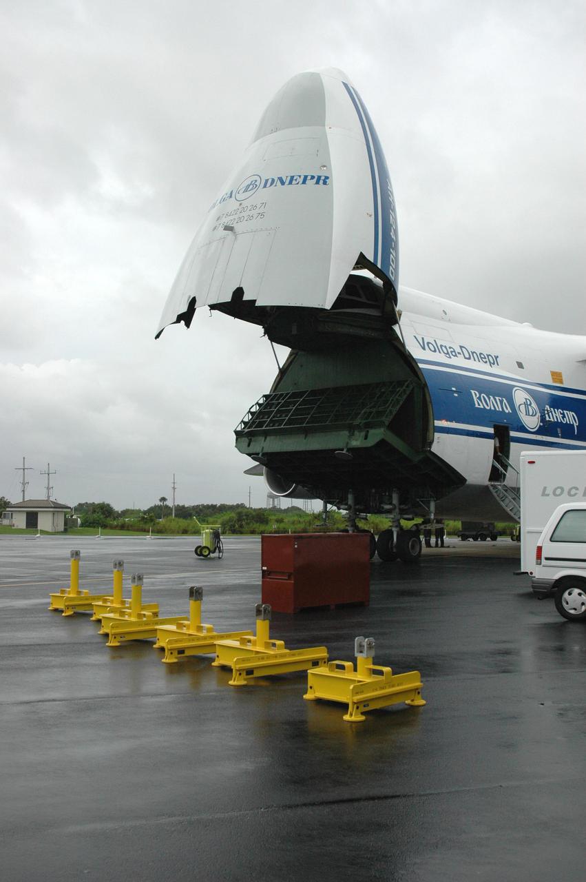 KENNEDY SPACE CENTER, FLA. — At the Cape Canaveral Air Force Station Skid Strip, the first stage of an Atlas V rocket arrives aboard a Russian air cargo plane. The Atlas V is the launch vehicle for the New Horizons spacecraft. New Horizons is designed to help us understand worlds at the edge of our solar system by making the first reconnaissance of Pluto and Charon - a 'double planet' and the last planet in our solar system to be visited by spacecraft. The mission will then visit one or more objects in the Kuiper Belt region beyond Neptune. New Horizons is scheduled to launch from Launch Complex 41 at CCAFS in January 2006, swing past Jupiter for a gravity boost and scientific studies in February or March 2007, and reach Pluto and its moon, Charon, in July 2015.