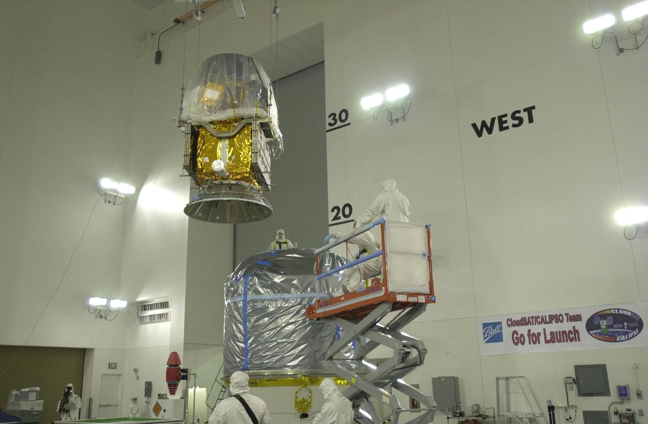 VANDENBERG AIR FORCE BASE, CALIF.  - Inside the Astrotech Payload Processing Facility on Vandenberg Air Force Base in California, the CALIPSO spacecraft is moved toward the Lower Delta Payload Attach Fitting (LDPAF).  CALIPSO will be mated with the LDPAF, which contains the CloudSat satellite.  The PAF is the interface between the spacecraft and the second stage of the rocket.  CALIPSO stands for Cloud-Aerosol Lidar and Infrared Pathfinder Satellite Observation. CALIPSO and CloudSat are highly complementary satellites that will provide never-before-seen 3-D perspectives of how clouds and aerosols form, evolve, and affect weather and climate. CALIPSO and CloudSat will fly in formation with three other satellites in the A-train constellation to enhance understanding of our climate system. Launch of CALIPSO_CloudSat aboard a Boeing Delta II rocket is scheduled for 3:01 a.m. PDT Sept. 29.