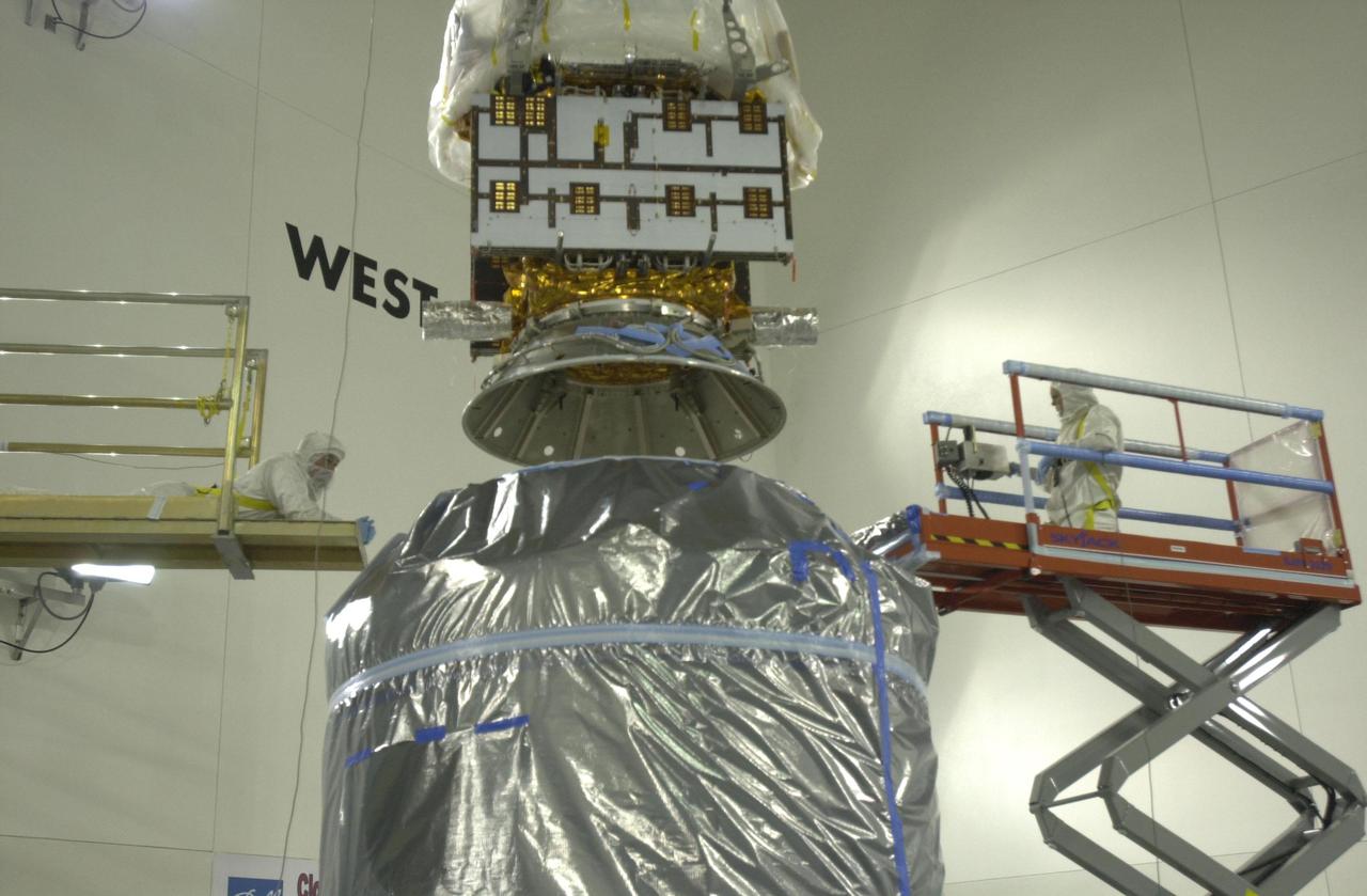 VANDENBERG AIR FORCE BASE, CALIF.  - Inside the Astrotech Payload Processing Facility on Vandenberg Air Force Base in California, the CALIPSO spacecraft is lowered closer to the Lower Delta Payload Attach Fitting (LDPAF).  CALIPSO will be mated with the LDPAF, which contains the CloudSat satellite.   The PAF is the interface between the spacecraft and the second stage of the rocket.  CALIPSO stands for Cloud-Aerosol Lidar and Infrared Pathfinder Satellite Observation. CALIPSO and CloudSat are highly complementary satellites that will provide never-before-seen 3-D perspectives of how clouds and aerosols form, evolve, and affect weather and climate. CALIPSO and CloudSat will fly in formation with three other satellites in the A-train constellation to enhance understanding of our climate system. Launch of CALIPSO_CloudSat aboard a Boeing Delta II rocket is scheduled for 3:01 a.m. PDT Sept. 29.