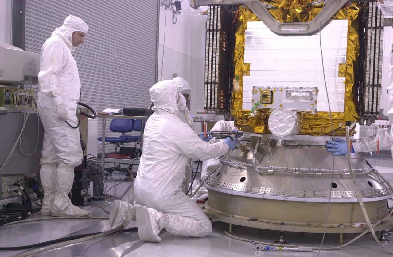 VANDENBERG AIR FORCE BASE, CALIF.  — Inside the Astrotech Payload Processing Facility on Vandenberg Air Force Base in California, workers check the attachment of the CALIPSO spacecraft onto the upper Delta Payload Attach Fitting (UDPAF).   Later the UDPAF will be mated with the lower Delta Payload Attach Fitting, which contains the CloudSat satellite. The PAF is the interface between the spacecraft and the second stage of the rocket. CALIPSO stands for Cloud-Aerosol Lidar and Infrared Pathfinder Satellite Observation.