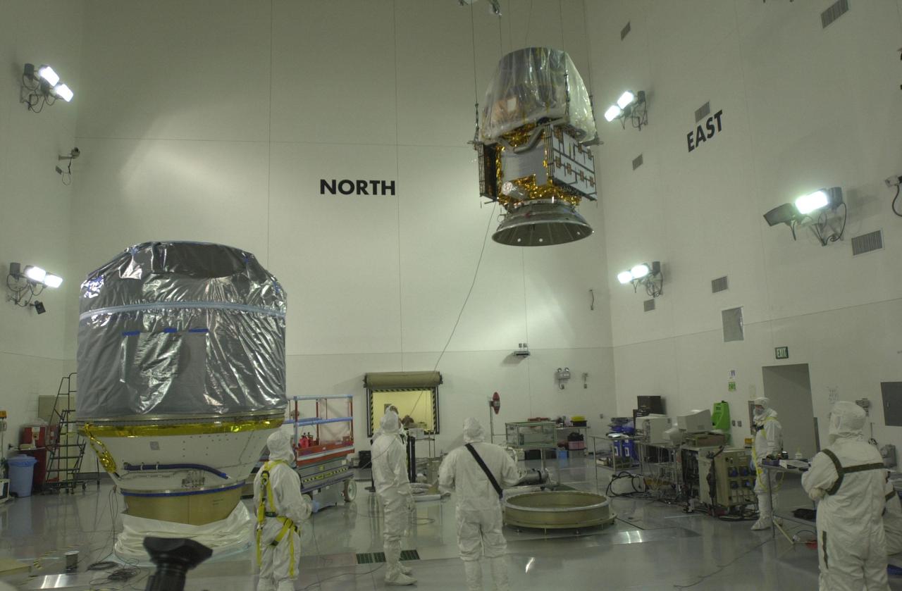 VANDENBERG AIR FORCE BASE, CALIF.  — Inside the Astrotech Payload Processing Facility on Vandenberg Air Force Base in California, workers move the CALIPSO spacecraft away from the Lower Delta Payload Attach Fitting, which contains the CloudSat satellite.  Later the UDPAF will be mated with the lower Delta Payload Attach Fitting, which contains the CloudSat satellite. The PAF is the interface between the spacecraft and the second stage of the rocket. CALIPSO stands for Cloud-Aerosol Lidar and Infrared Pathfinder Satellite Observation.