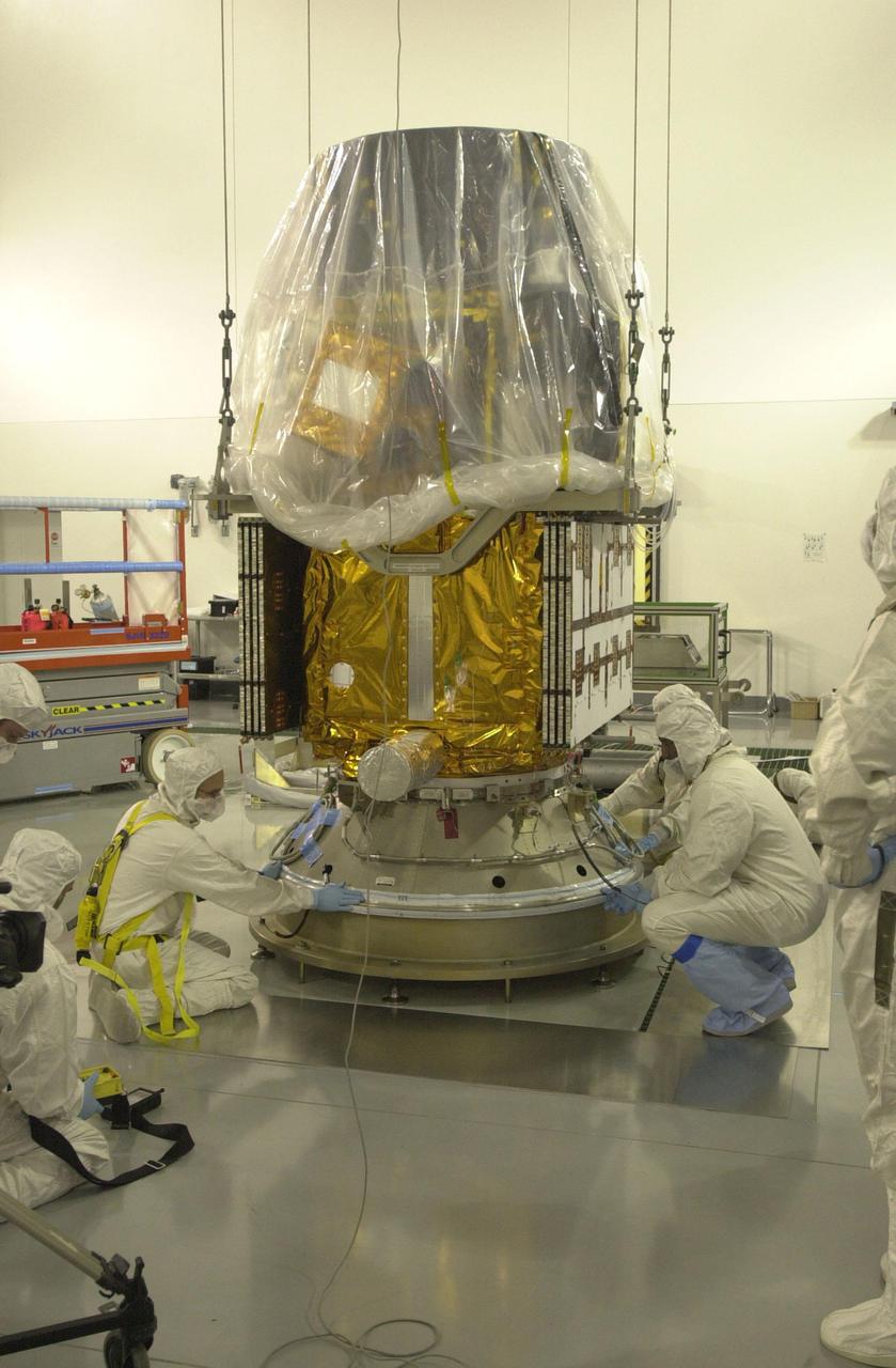 VANDENBERG AIR FORCE BASE, CALIF.  — Inside the Astrotech Payload Processing Facility on Vandenberg Air Force Base in California, workers check the Upper Delta Payload Attach Fitting (UDPAF) holding the CALIPSO spacecraft.  CALIPSO will be mated with the Lower Delta Payload Attach Fitting (LDPAF) that contains the CloudSat satellite.  The PAF is the interface between the spacecraft and the second stage of the rocket. CALIPSO stands for Cloud-Aerosol Lidar and Infrared Pathfinder Satellite Observation.