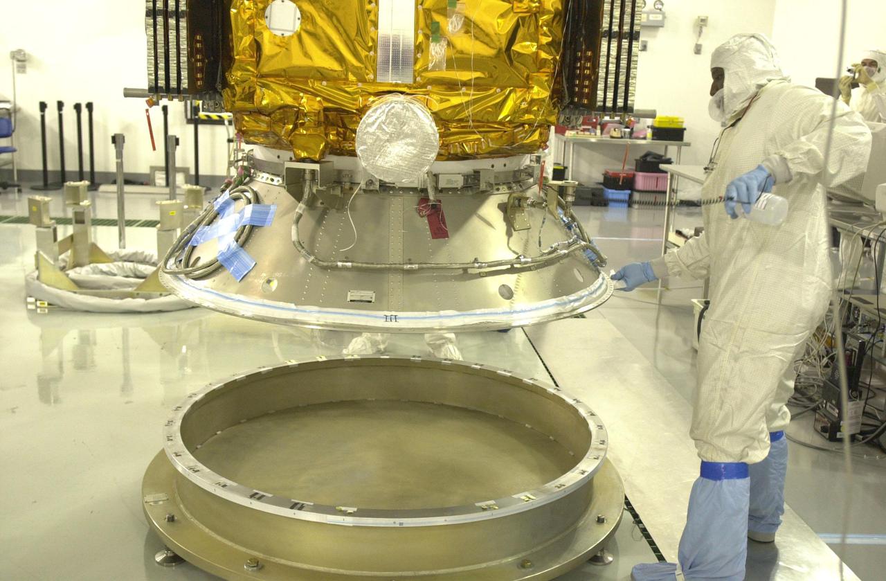 VANDENBERG AIR FORCE BASE, CALIF.  — Inside the Astrotech Payload Processing Facility on Vandenberg Air Force Base in California, workers lift the CALIPSO spacecraft from the Upper Delta Payload Attach Fitting (UDPAF) to adjust the attachment.  CALIPSO will be mated with the Lower Delta Payload Attach Fitting (LDPAF) that contains the CloudSat satellite.  The PAF is the interface between the spacecraft and the second stage of the rocket. CALIPSO stands for Cloud-Aerosol Lidar and Infrared Pathfinder Satellite Observation.