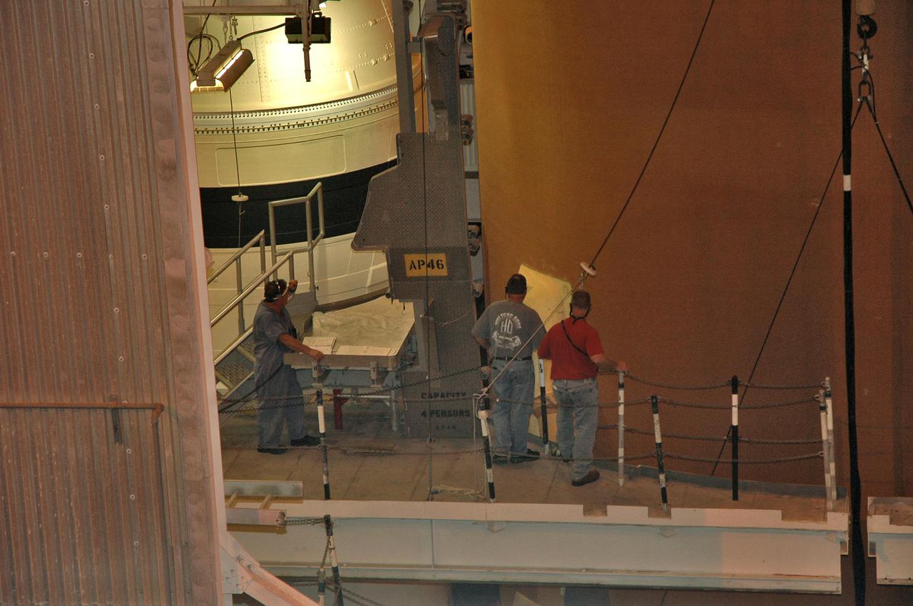 KENNEDY SPACE CENTER, FLA. - In NASA Kennedy Space Center’s Vehicle Assembly Building, workers secure the guidelines of an overhead crane on an external tank. The tank is being demated from the solid rocket boosters originally scheduled to fly on mission STS-121 with Space Shuttle Atlantis. It will temporarily be stored in a checkout cell in the VAB and await assignment to a future mission.