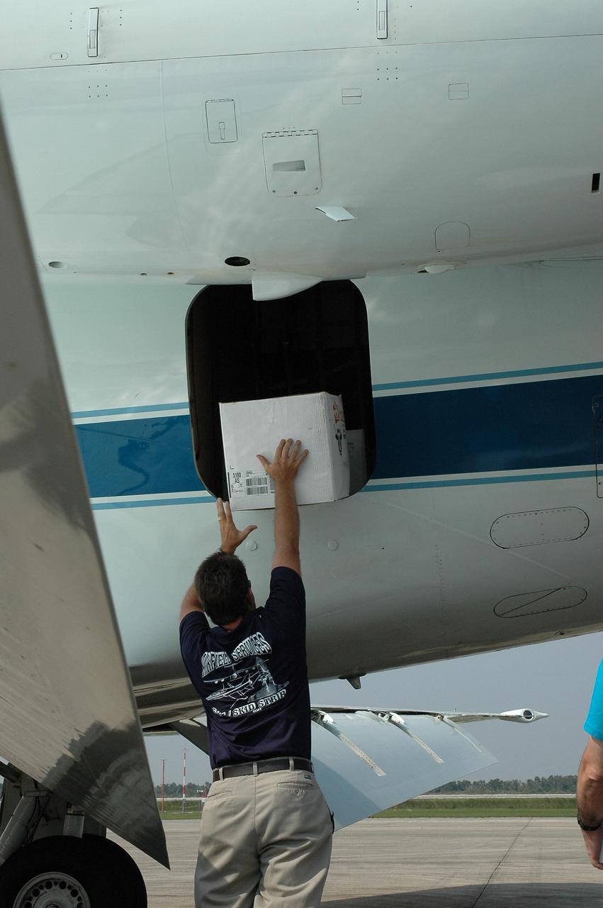 KENNEDY SPACE CENTER, FLA. - At the NASA Kennedy Space Center Shuttle Landing Facility, an employee lifts a box of hurricane relief supplies onto a NASA aircraft bound for Stennis Space Center in Mississippi, which suffered damage from Hurricane Katrina.   The supplies included 10 boxes of load bus disconnects going to Michoud Assesmbly Facility near New Orleans and 17 boxes of personal hygiene items, along with boxes of clothing and water.  Many Stennis and Michoud employees were rendered homeless by the hurricane.  NASA centers have been generous with relief supplies and personnel.  Stennis is in limited operations mode.  Daily convoys have been moving between Stennis and Michould, transporting personnel and supplies as Michoud prepares to resume limited operations.