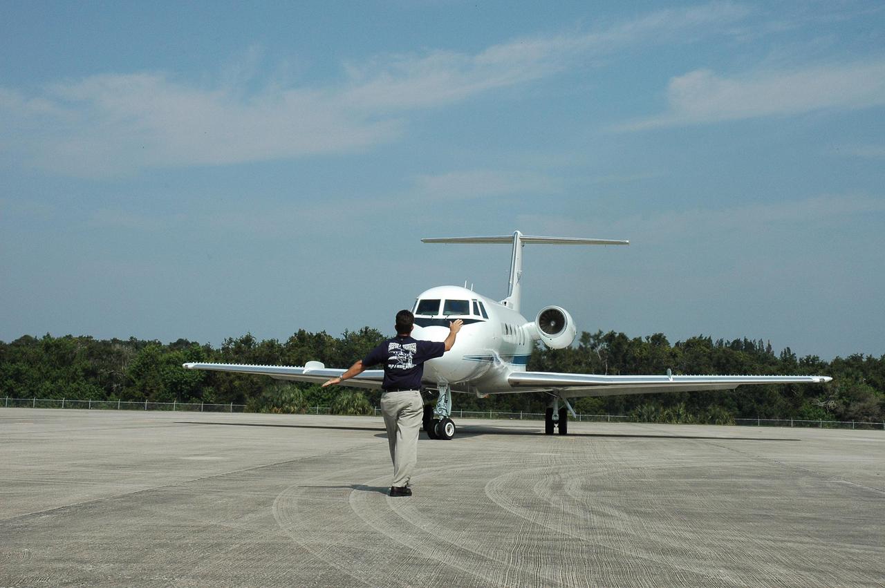 KENNEDY SPACE CENTER, FLA. - At the NASA Kennedy Space Center Shuttle Landing Facility, the NASA aircraft filled with hurricane relief supplies taxis into position for takeoff.  The plane is bound for Stennis Space Center in Mississippi, which suffered damage from Hurricane Katrina.  The two men with backs to the camera are Security personnel going to Stennis to relieve others who have been helping at the center. The supplies included 10 boxes of load bus disconnects going to Michoud Assesmbly Facility near New Orleans and 17 boxes of personal hygiene items, along with boxes of clothing and water.  Many Stennis and Michoud employees were rendered homeless by the hurricane.  NASA centers have been generous with relief supplies and personnel.  Stennis is in limited operations mode.  Daily convoys have been moving between Stennis and Michould, transporting personnel and supplies as Michoud prepares to resume limited operations.