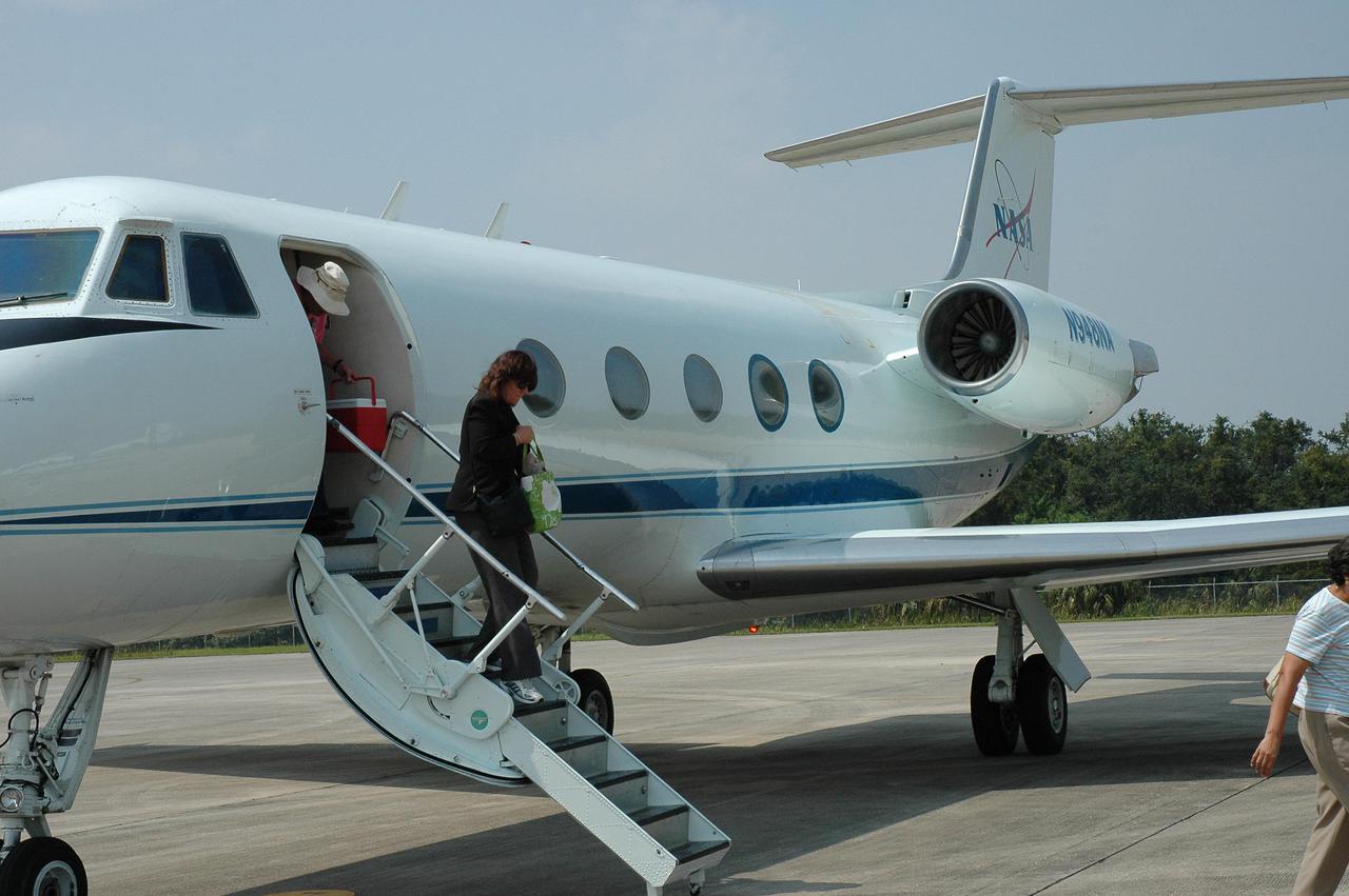KENNEDY SPACE CENTER, FLA. -  Patti Bell steps down the steps of the NASA aircraft on her return from Stennis Space Center in Mississippi.  Bell is with Environmental and Occupational Health at KSC.  She was part of a volunteer team helping rescue and recovery efforts at Stennis, which was damaged during Hurricane Katrina.  Many employees of Stennis and Michoud Assembly Facility, near New Orleans, were rendered homeless by the hurricane.  NASA centers have been generous with relief supplies and personnel.  Stennis is now in limited operations mode.  Daily convoys have been moving between Stennis and Michoud, transporting personnel and supplies as Michoud prepares to resume limited operations.