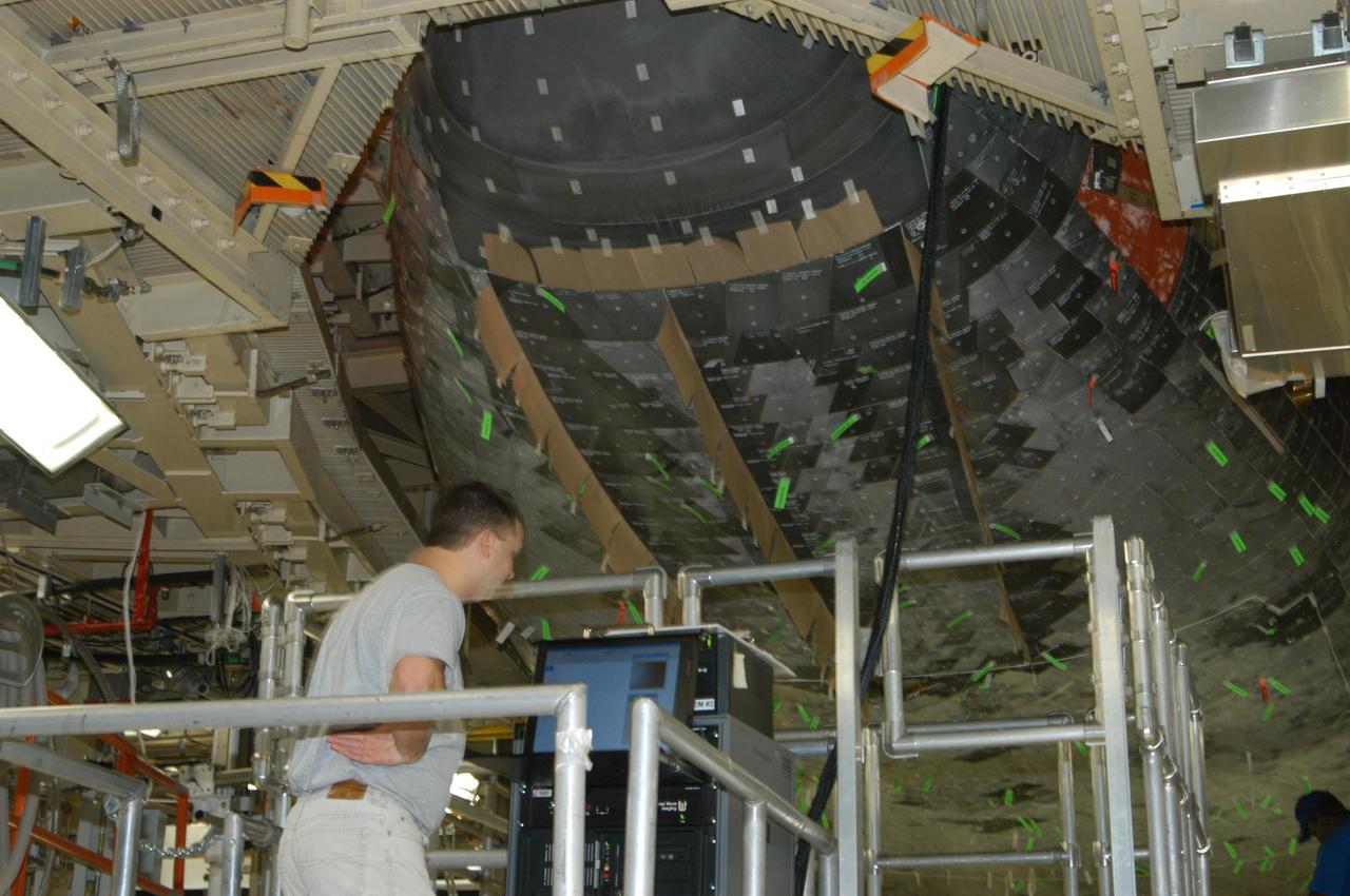 KENNEDY SPACE CENTER, FLA. - In NASA Kennedy Space Center’s Orbiter Processing Facility, bay 3, Pat Cerny, with United Space Alliance, monitors readings from thermography testing on Discovery’s nose cone.Thermography uses high-intensity light to heat specific areas, which are then immediately scanned with an infrared camera. As the area cools, internal flaws are revealed. Discovery has been identified as the orbiter to fly on mission STS-121.