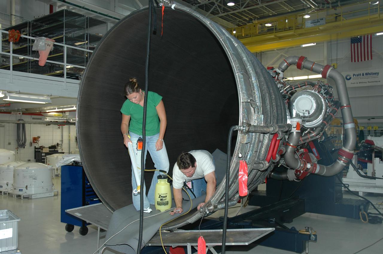 KENNEDY SPACE CENTER, FLA. - In NASA Kennedy Space Center’s Orbiter Processing Facility, bay 3, workers clean the inside of the bell on a space shuttle main engine removed from the orbiter Discovery. The orbiter will be processed for the second Return to Flight mission, STS-121.