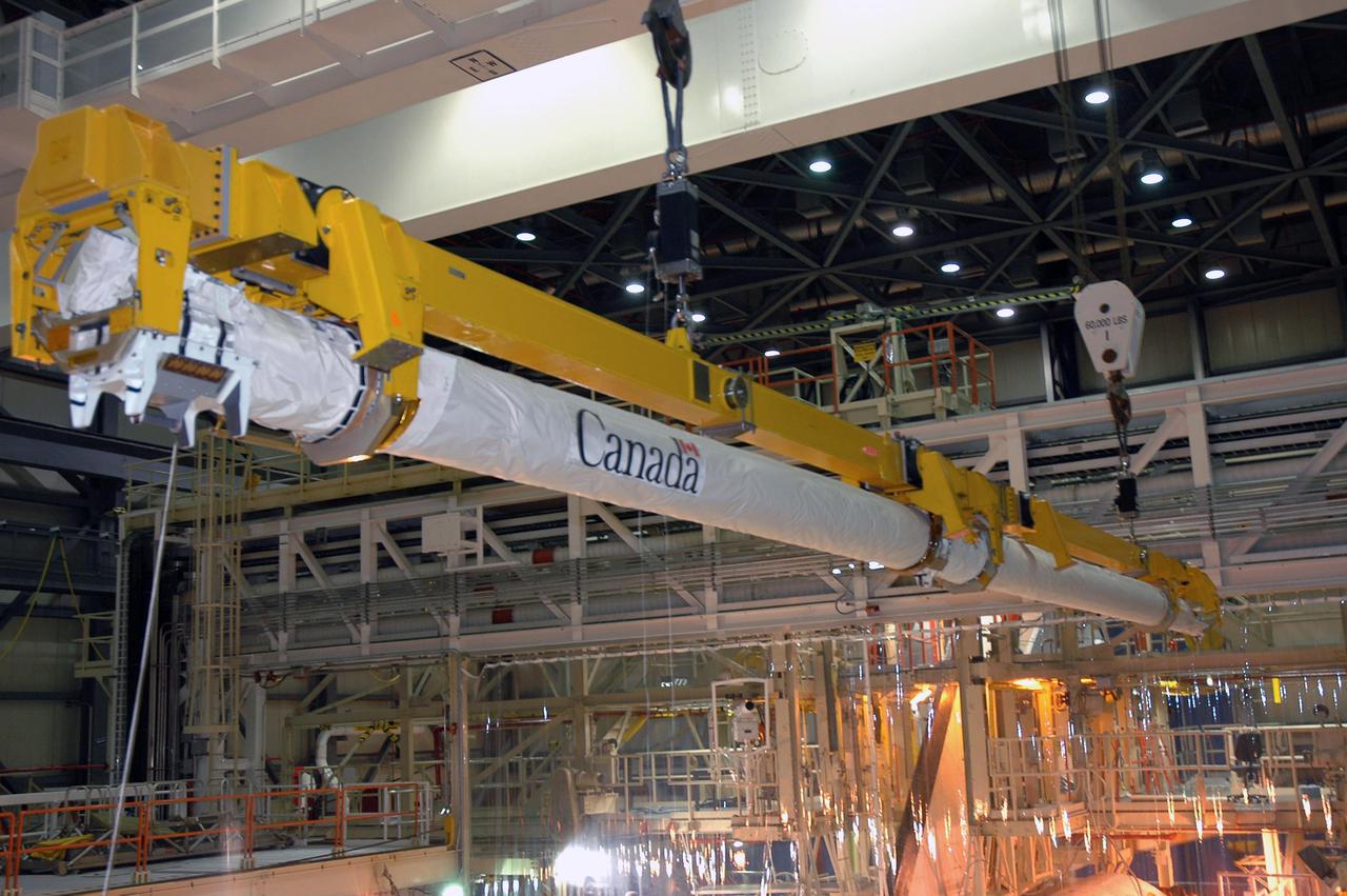 KENNEDY SPACE CENTER, FLA. - In NASA Kennedy Space Center’s Orbiter Processing Facility, bay 3, the the Canadian-built orbiter boom sensor system robotic arm is lifted away from Discovery. The boom, which was was used on Return to Flight mission STS-114 to provide more extensive inspection and photography of Discovery, will undergo inspection. The orbiter will be processed for the second Return to Flight mission, STS-121.