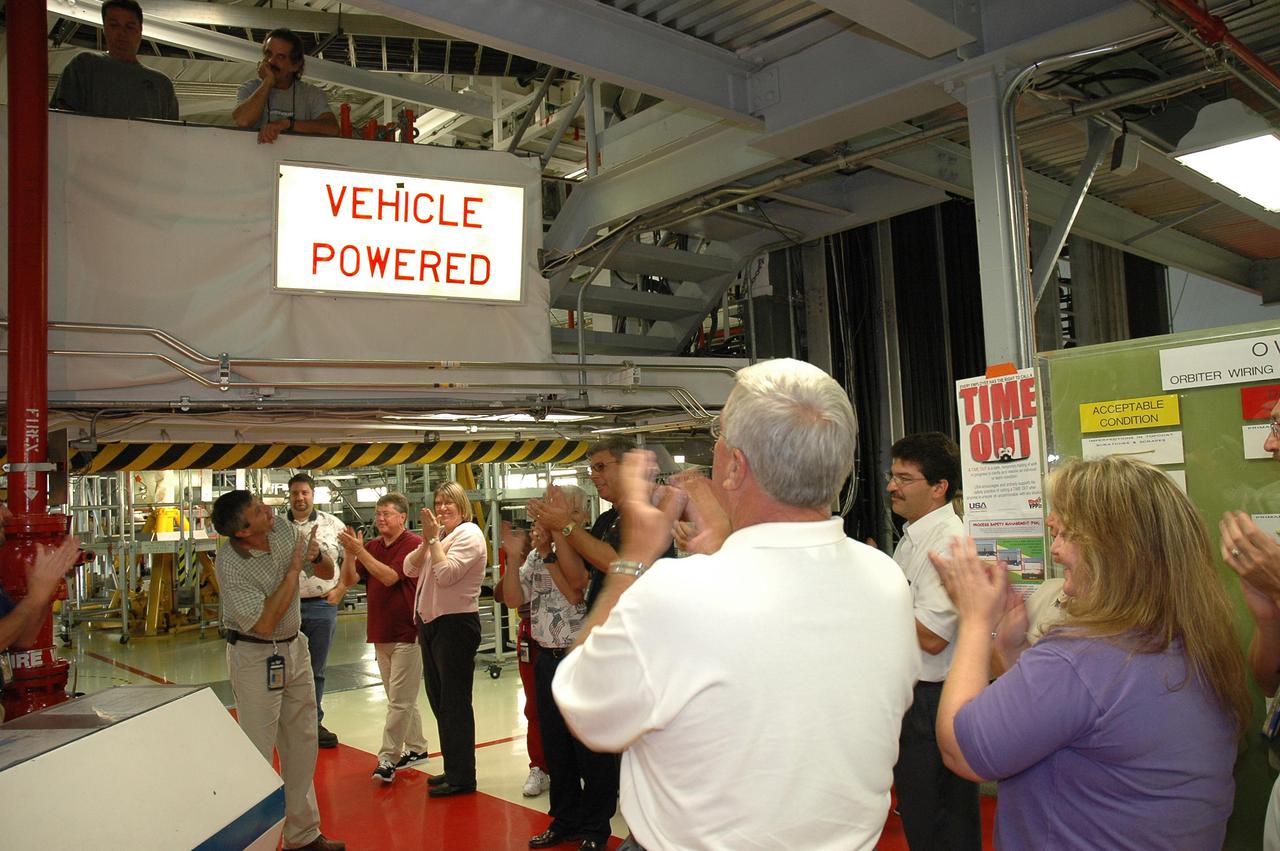 KENNEDY SPACE CENTER, FLA. - In NASA’s Orbiter Processing Facility bay 2, workers applaud as the orbiter Endeavour’s electrical system is partially powered up, after nearly 2 years. Full power-up will take place in October. Endeavour has been in its Orbiter Major Modification period, which began in December 2003. In that time, 124 modifications were completed, including installing the glass cockpit; 150 miles of wiring were inspected; and more than 1,000 tiles were bonded. This is the second full modification conducted at Kennedy.
