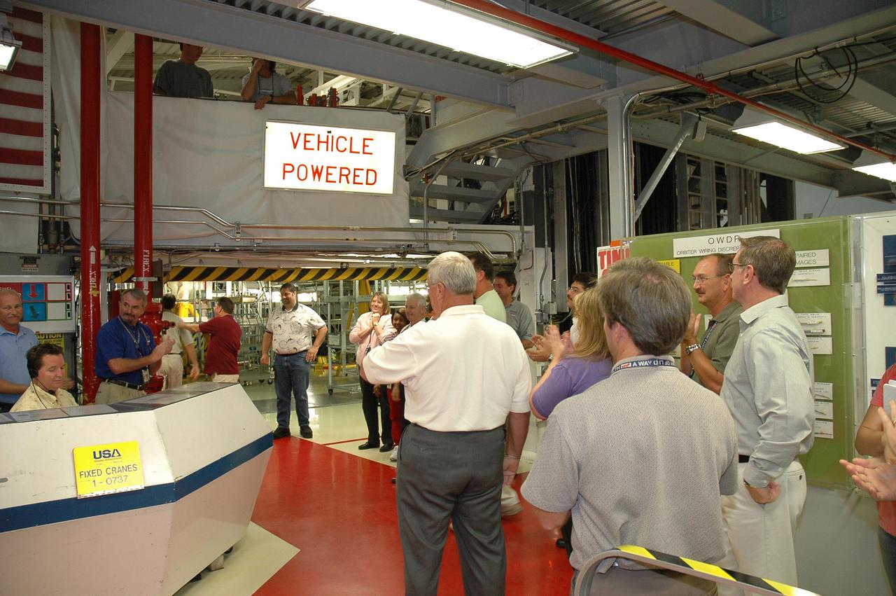 KENNEDY SPACE CENTER, FLA. - In NASA’s Orbiter Processing Facility bay 2, workers gather as the orbiter Endeavour’s electrical system is partially powered up, after nearly 2 years. Full power-up will take place in October. Endeavour has been in its Orbiter Major Modification period, which began in December 2003. In that time, 124 modifications were completed, including installing the glass cockpit; 150 miles of wiring were inspected; and more than 1,000 tiles were bonded. This is the second full modification conducted at Kennedy.