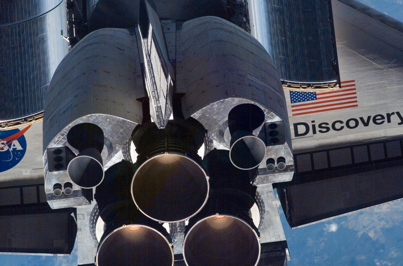 A close-up view of Space Shuttle Discovery's tail section is featured in this image photographed by an Expedition 13 crew member on the International Space Station (ISS) during the STS-121 Rotating Pitch Maneuver (RPM) survey. Visible are the space shuttle's main engines (SSME), vertical stabilizer, orbital maneuvering system (OMS) pods and a portion of the aft cargo bay and wings. The Marshall Space Flight Center (MSFC) has management responsibility for development of the SSME. 