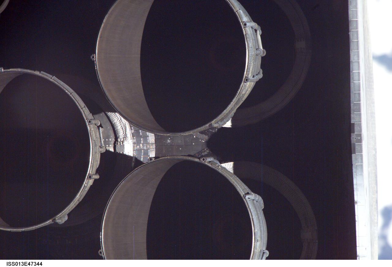 The nozzles for Discovery's three main engines are visible in this close-up image photographed by one of the Expedition 13 crew members onboard the International Space Station (ISS) during the STS-121 Rotating Pitch Maneuver (RPM) survey prior to docking of the two spacecraft. The Marshall Space Flight Center (MSFC) has management responsibility for development of the space shuttle main engines (SSME).