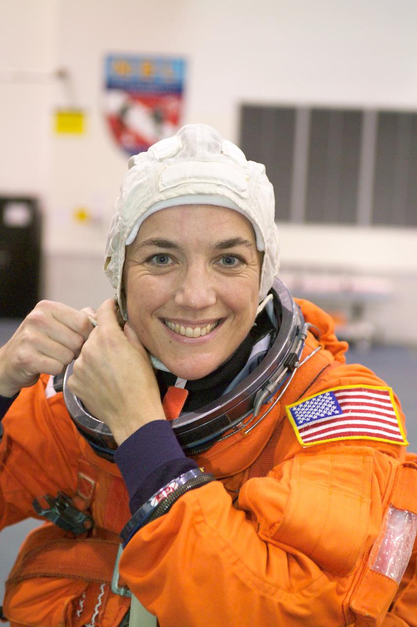 Wearing a training version of the shuttle launch and entry suit, STS-115 astronaut and mission specialist, Heidemarie M. Stefanyshyn-Piper, puts the final touches on her suit donning process prior to the start of a water survival training session in the Neutral Buoyancy Laboratory (NBL) near Johnson Space Center. Launched on September 9, 2006, the STS-115 mission continued assembly of the International Space Station (ISS) with the installation of the truss segments P3 and P4.   