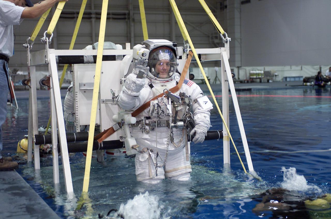 Attired in a training version of the Extravehicular Mobility Unit (EMU) space suit, STS-115 astronaut and mission specialist, Heidemarie M. Stefanyshyn-Piper, is submerged into the waters of the Neutral Buoyancy Laboratory (NBL) near Johnson Space Center for training in preparation for the STS-115 mission. Launched on September 9, 2006, the STS-115 mission continued assembly of the International Space Station (ISS) with the installation of the truss segments P3 and P4.