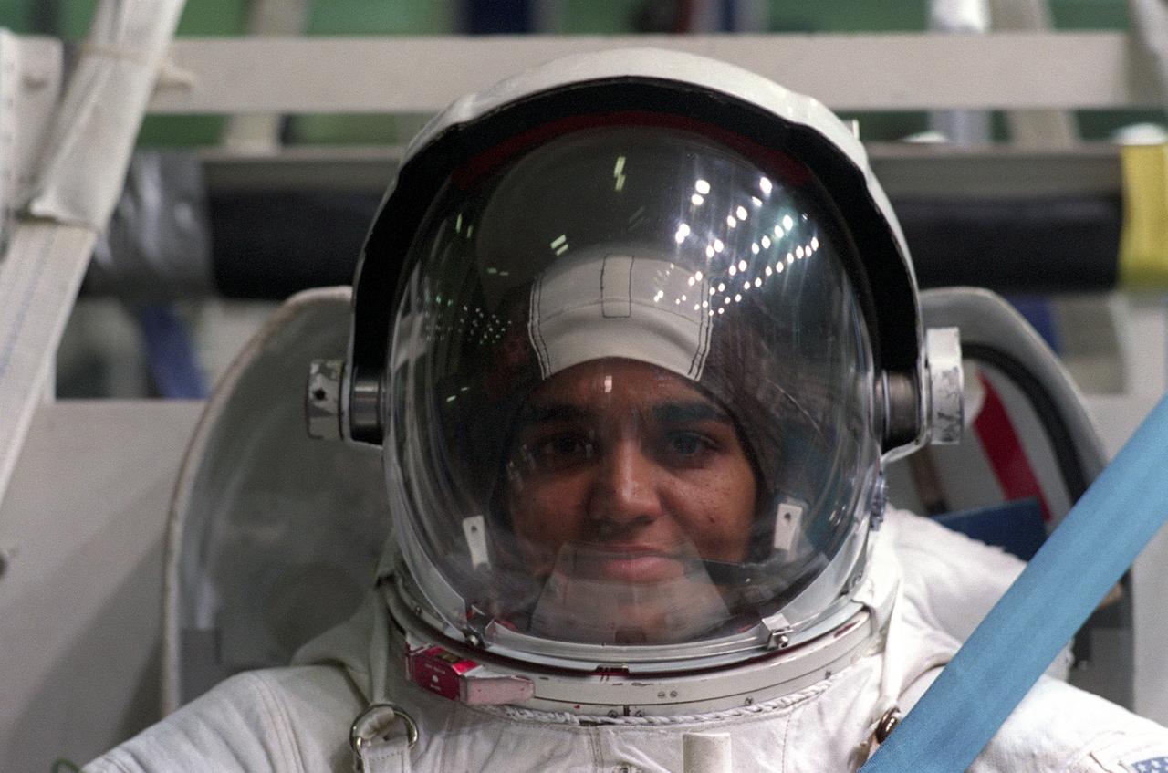 Attired in a training version of the Extravehicular Mobility Unit (EMU) space suit, astronaut and mission specialist Kalpana Chawla, prepares to go underwater in the Neutral Buoyancy Laboratory (NBL) near Johnson Space Center. This particular training was in preparation for the STS-87 mission. The Space Shuttle Columbia (STS-87) was the fourth flight of the United States Microgravity Payload (USMP-4) and Spartan-201 satellite, both managed by scientists and engineers from the Marshall Space Flight Center.           