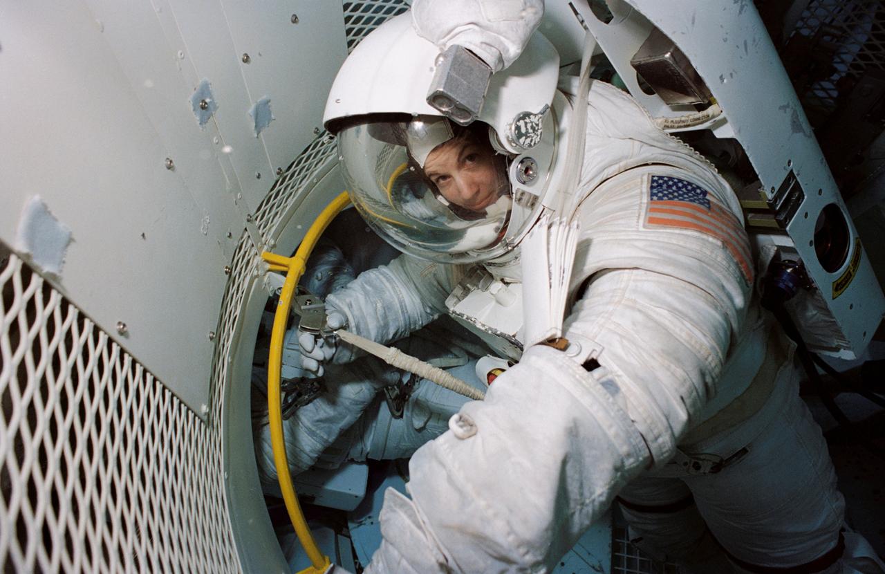 Astronaut and mission specialist Catherine G. Coleman,attired in a high fidelity training version of the Extravehicular Mobility Unit (EMU) space suit, trains for a contingency space walk at the Johnson Space Center’s (JSC) Weightless Environment Training Facility (WET-F). This particular training was in preparation for the STS-73 mission. The STS-73 mission was the second flight of the United States Microgravity Laboratory (USML-2), managed by scientists and engineers from the Marshall Space Flight Center.