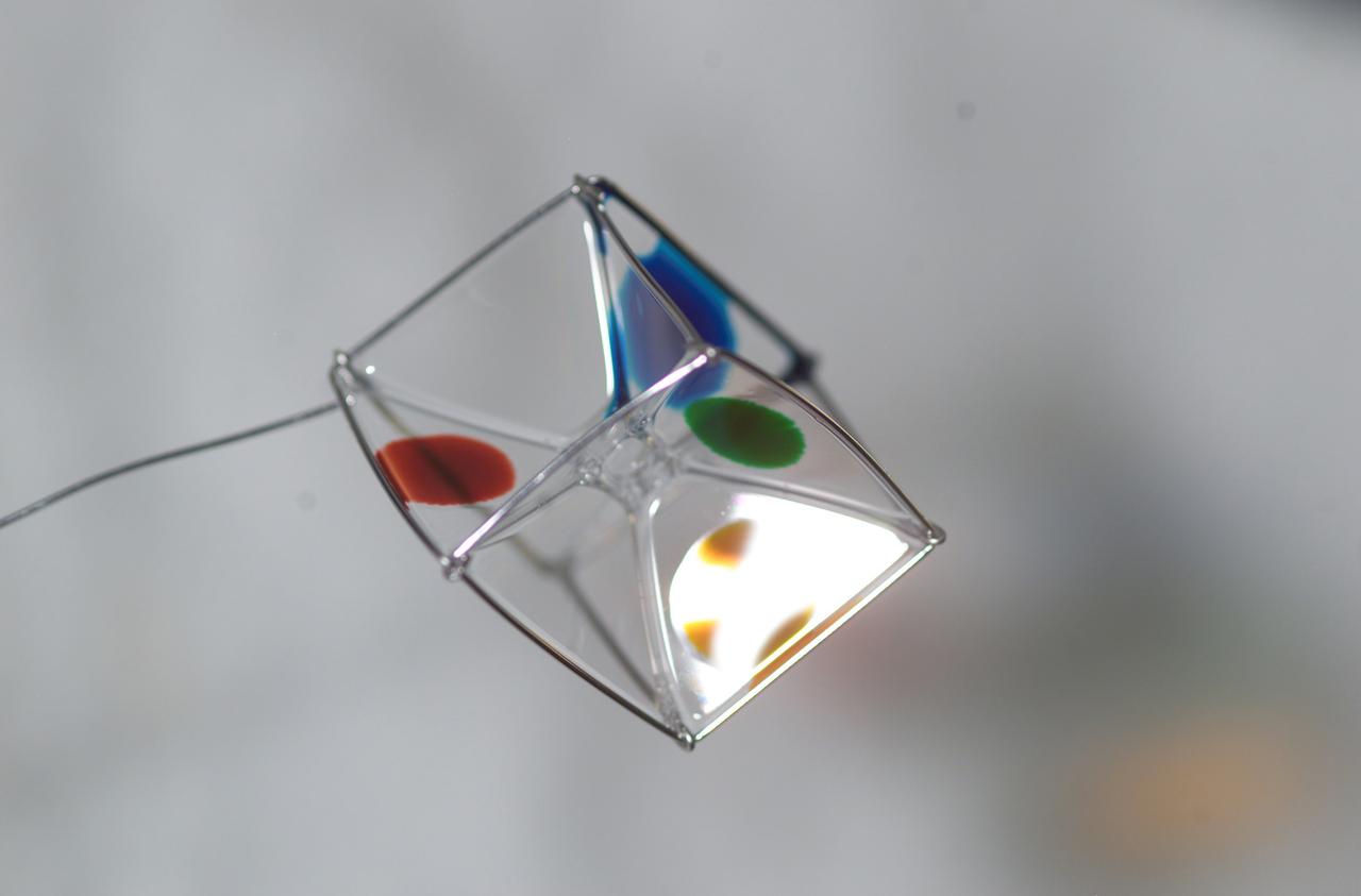 Expedition 6 astronaut Dr. Don Pettit photographed a cube shaped wire frame supporting a thin film made from a water-soap solution during his Saturday Morning Science aboard the International Space Station’s (ISS) Destiny Laboratory. Food coloring was added to several faces to observe the effects of diffusion within the film. 