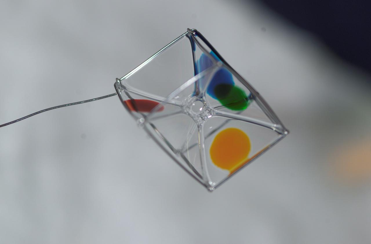 Expedition 6 astronaut Dr. Don Pettit photographed a cube shaped wire frame supporting a thin film made from a water-soap solution during his Saturday Morning Science aboard the International Space Station’s (ISS) Destiny Laboratory. Food coloring was added to several faces to observe the effects of diffusion within the film. 