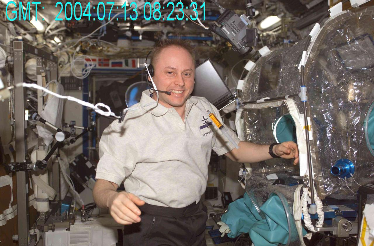 Astronaut Mike Fincke places droplets of honey onto the strings for the Fluid Merging Viscosity Measurement (FMVM) investigation onboard the International Space Station (ISS). The FMVM experiment measures the time it takes for two individual highly viscous fluid droplets to coalesce or merge into one droplet. Different fluids and droplet size combinations were tested in the series of experiments.  By using the microgravity environment, researchers can measure the viscosity or "thickness" of fluids without the influence of containers and gravity using this new technique. Understanding viscosity could help scientists understand industrially important materials such as paints, emulsions, polymer melts and even foams used to produce pharmaceutical, food, and cosmetic products.