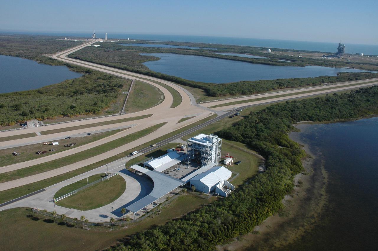 KENNEDY SPACE CENTER, FLA. - This aerial view on NASA's Kennedy Space Center shows the Launch Complex 39 Observation Gantry in the foreground, the crawlerways leading to the launch pads, and space shuttle Launch Complex 39 Pad A (left) and Pad B in the background, silhouetted by the Atlantic Ocean. Photo credit: Cory Huston