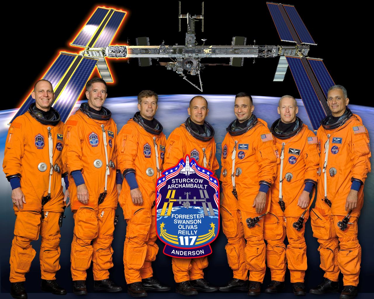 These six STS 117 astronauts, assigned to launch aboard the Space Shuttle Atlantis, are (from the left) astronauts James F. Reilly II, Steven R. Swanson, mission specialists; Frederick W. (Rick) Sturckow, commander; Lee J. Archambault, pilot; and Patrick G. Forrester and John D. (Danny) Olivas, mission specialists. The crewmembers are attired in training versions of their shuttle launch and entry suits. Mission objectives include the addition of the second and third starboard truss segments (S3/S4) with Photovoltaic Radiator (PVR), the deployed third set of solar arrays. The P6 starboard solar array wing and one radiator are to be retracted.