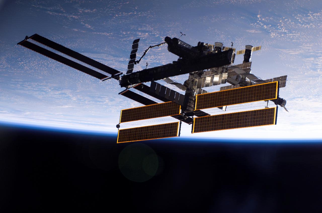This view of the International Space Station, back dropped against the blackness of space and Earth, was taken shortly after the Space Shuttle Atlantis undocked from the orbital outpost at 7:50 a.m. CDT during the STS-115 mission. The unlinking completed after six days, two hours and two minutes of joint operations of the installation of the P3/P4 truss. The new 17 ton truss included batteries, electronics, a giant rotating joint, and sported a second pair of 240-foot solar wings. The new solar arrays will eventually double the onboard power of the Station when their electrical systems are brought online during the next shuttle flight, STS-116. 