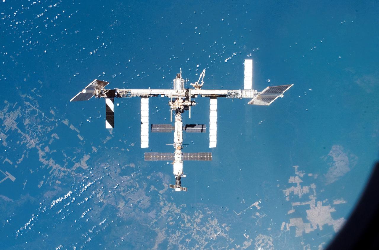 Eight days of construction resumed on the International Space Station (ISS), as STS-117 astronauts and mission specialists and the Expedition 15 crew completed installation of the second and third starboard truss segments (S3 and S4). Back dropped by our colorful Earth, its  newly expanded configuration is revealed as pilot Lee Archambault conducts a fly around upon departure from the station on June 19, 2007.