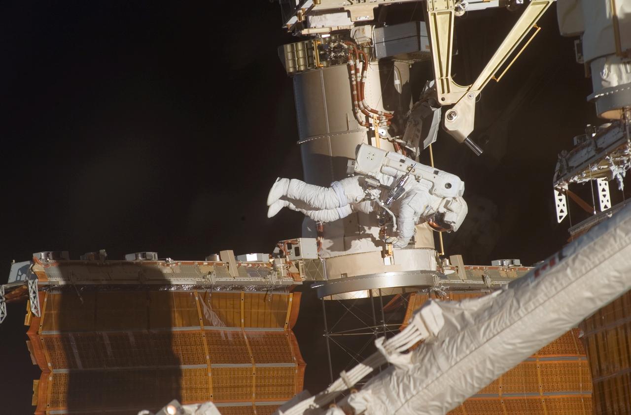 Astronaut Doug Wheelock, STS-120 mission specialist, participated in the mission's fourth session of extravehicular activity (EVA) while Space Shuttle Discovery was docked with the International Space Station (ISS). During the 7-hour and 19-minute space walk, astronaut Scott Parazynski (out of frame), mission specialist, cut a snagged wire and installed homemade stabilizers designed to strengthen the structure and stability of the damaged P6 4B solar array wing. Wheelock assisted from the truss by keeping an eye on the distance between Parazynski and the array. Once the repair was complete, flight controllers on the ground successfully completed the deployment of the array.